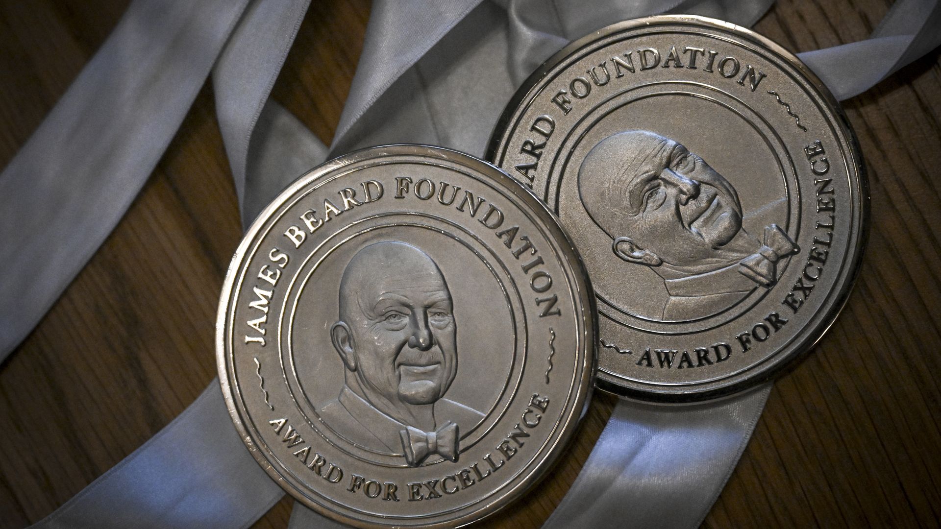 Two James Beard medals sit on a table. 