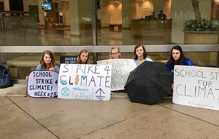 Climate activists including Mary Ellis Stevens protest in front of the government center uptown 