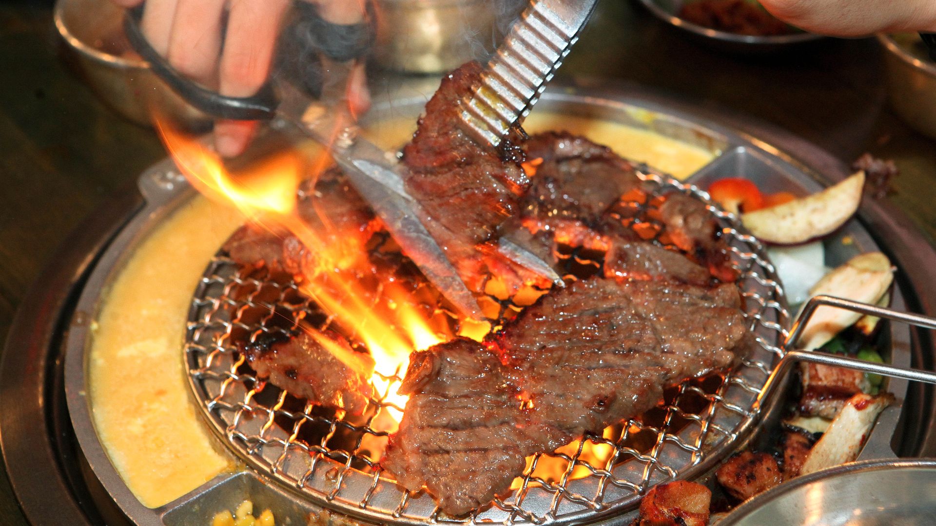 Galbi beef on a small, open flame burner.