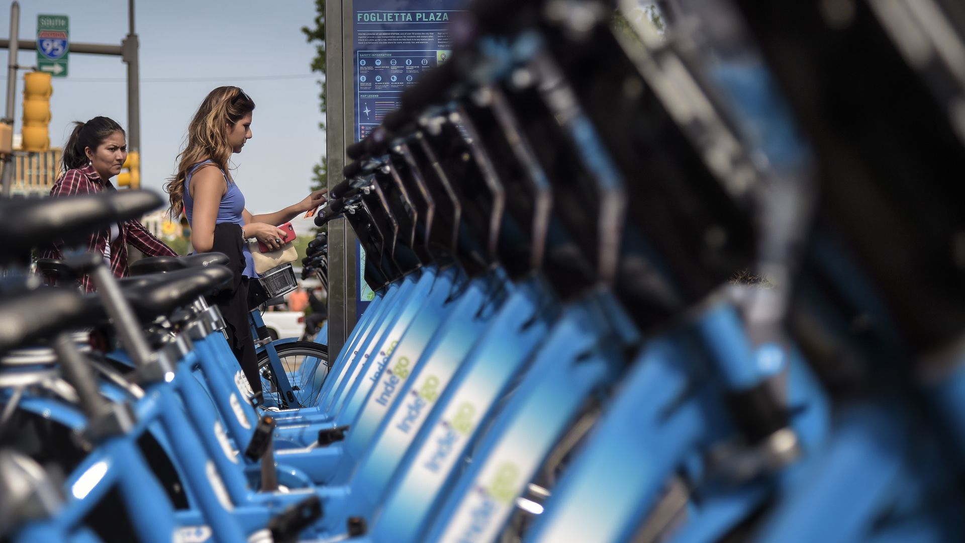 A row of Indego bikes at a docking station.