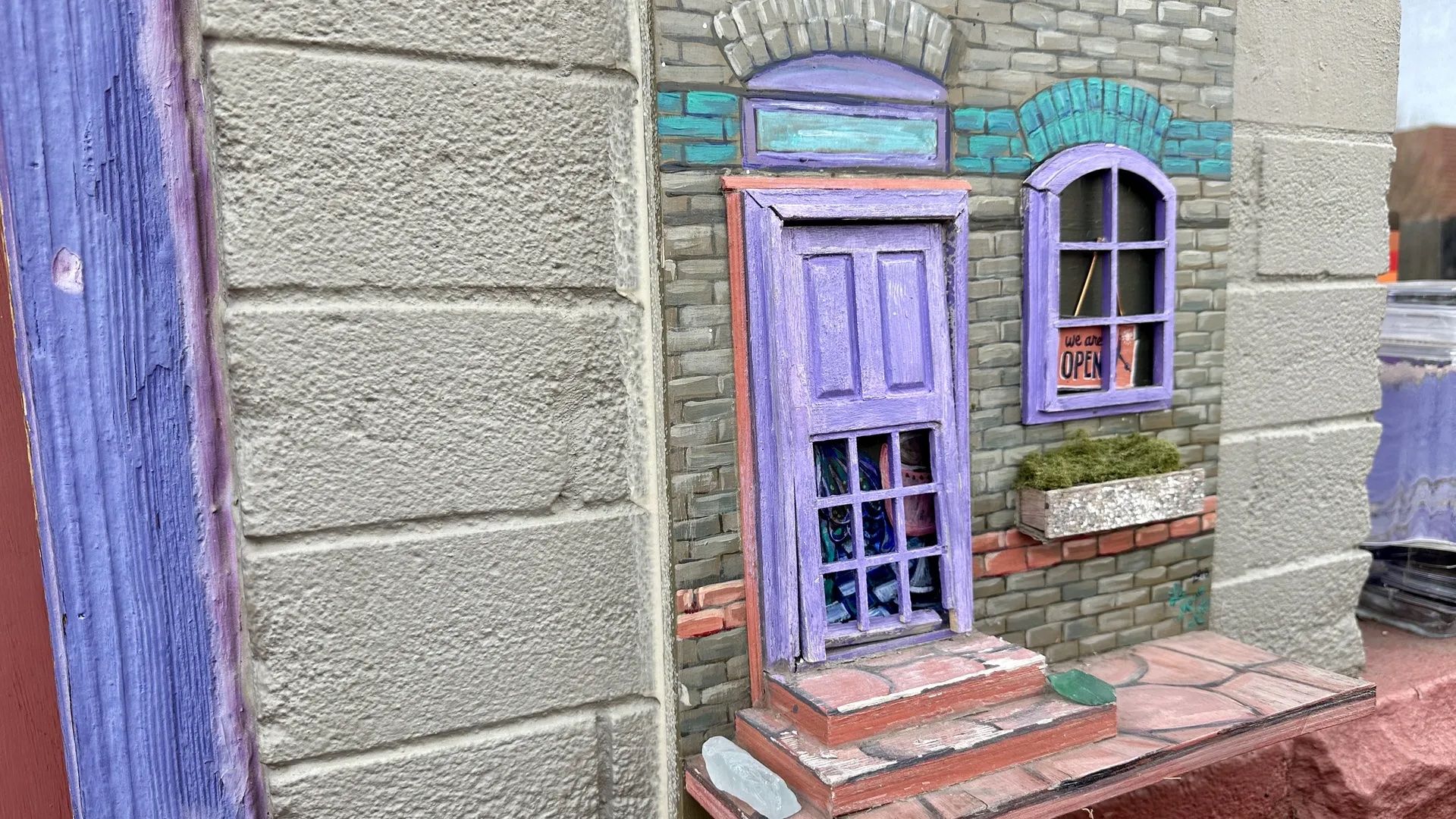 A small purple fairy door