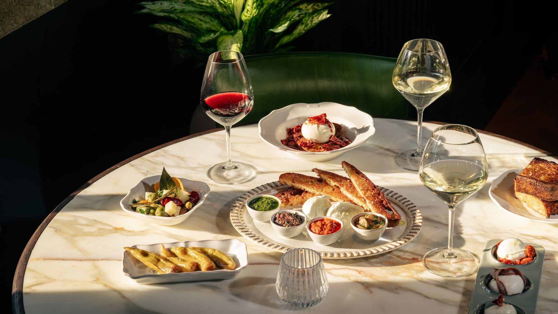 A marble table at Osteria Mozza with Italian dishes and wine