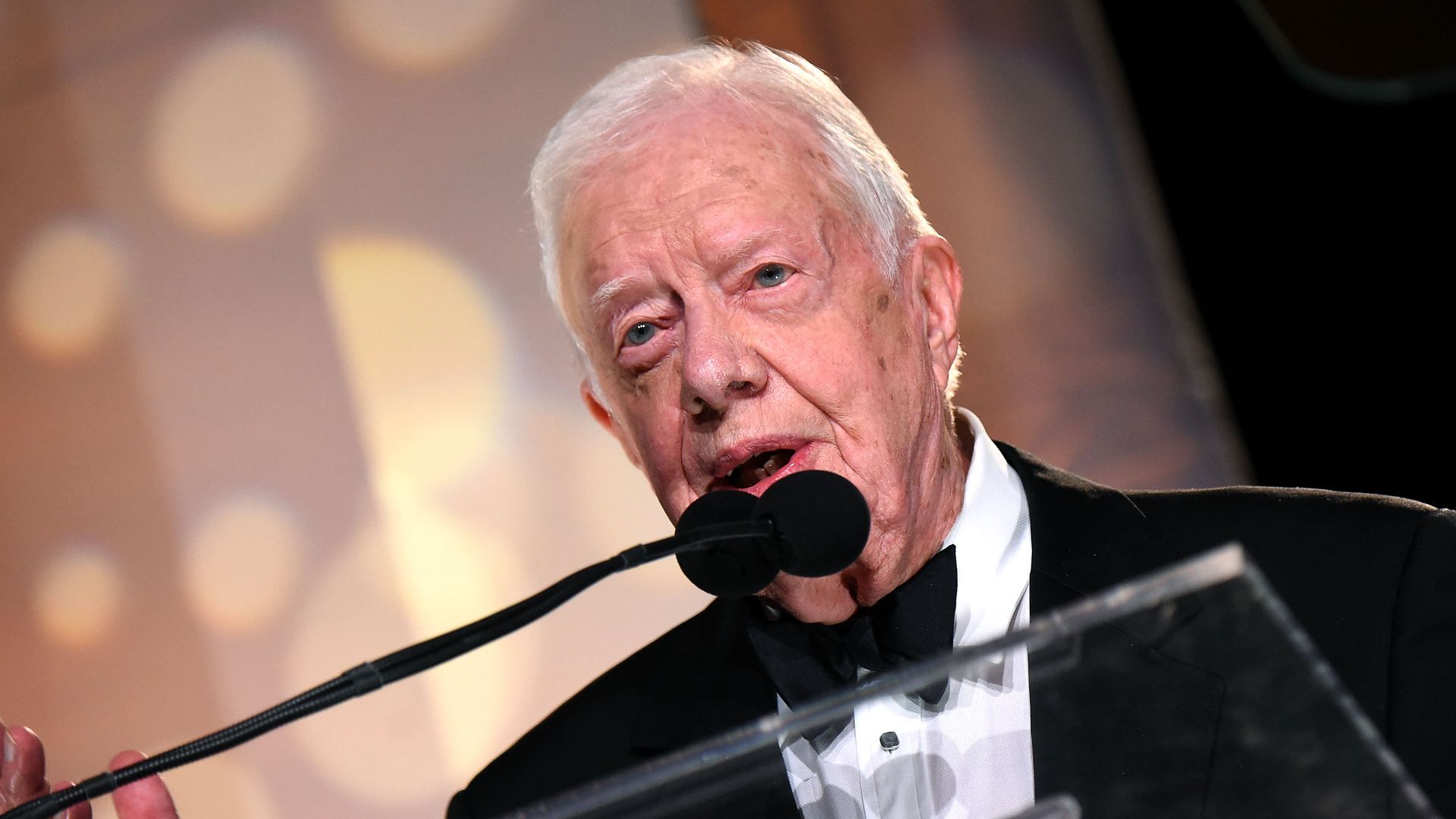 Photo of Jimmy Carter speaking into a mic at a formal event