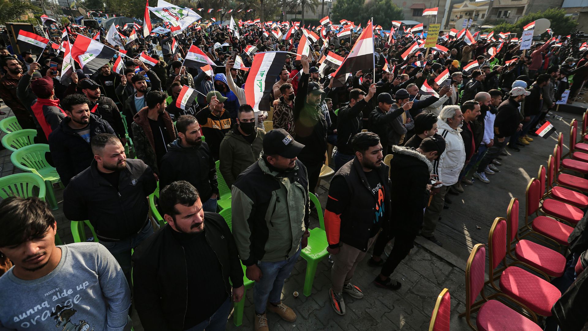 Supporters of Asa'ib Ahl al-Haq and Hezbollah Brigades groups rally in Baghdad, Iraq on Dec. 31, 2021. Photo: Ameer Al Mohammedaw/picture alliance via Getty Images