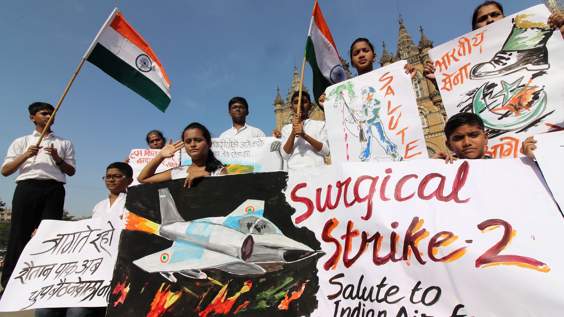 Indians hold placard as they celebrate after the Indian Air Force's air strike on a Jaish-e-Mohammad terror camp in Pakistan, outside a mosque in Mumbai, India on 26 February 2019.