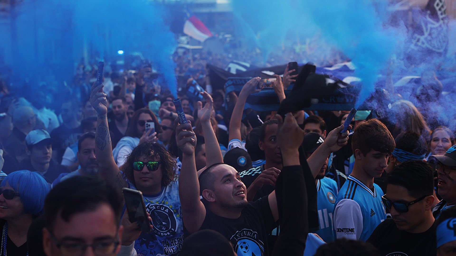 Supporters march toward Charlotte FC’s inaugural home match at Bank of America Stadium on March 5, 2022. (Travis Dove for Axios Charlotte)