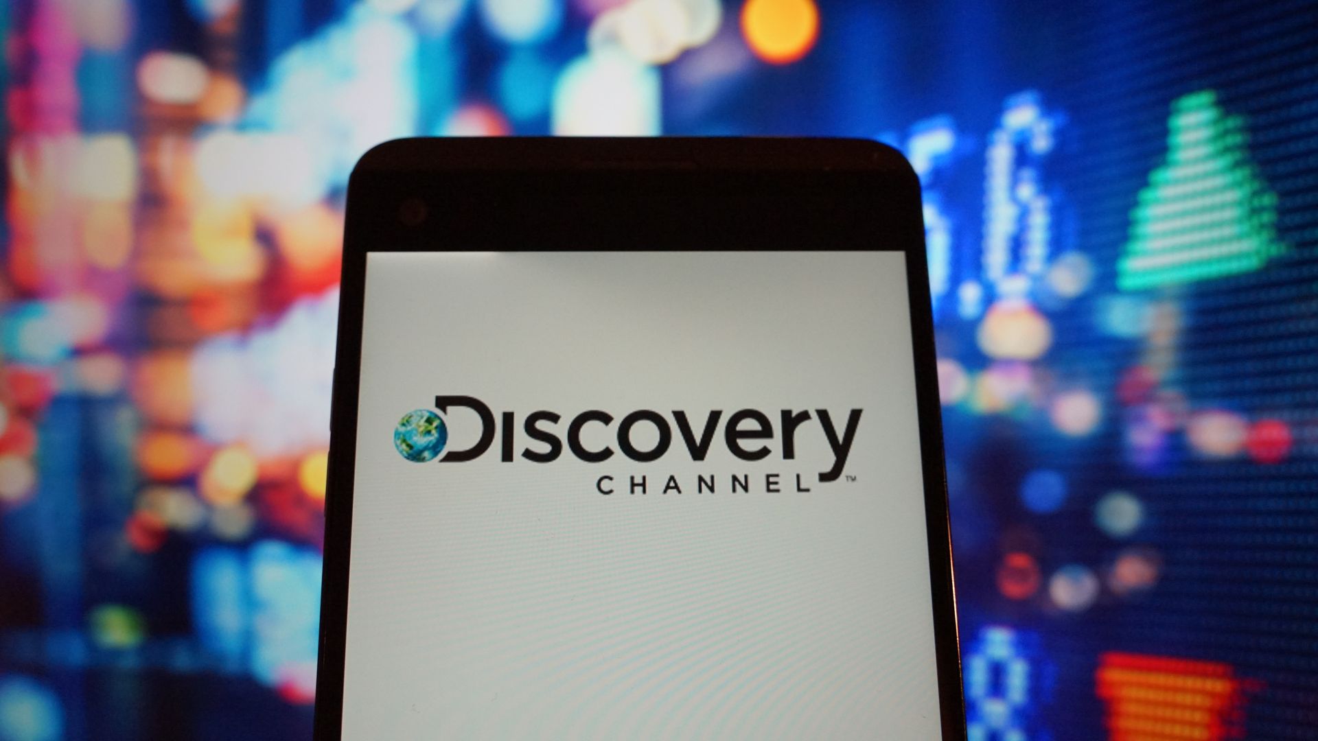 The logo of the Discovery Channel on a smartphone.