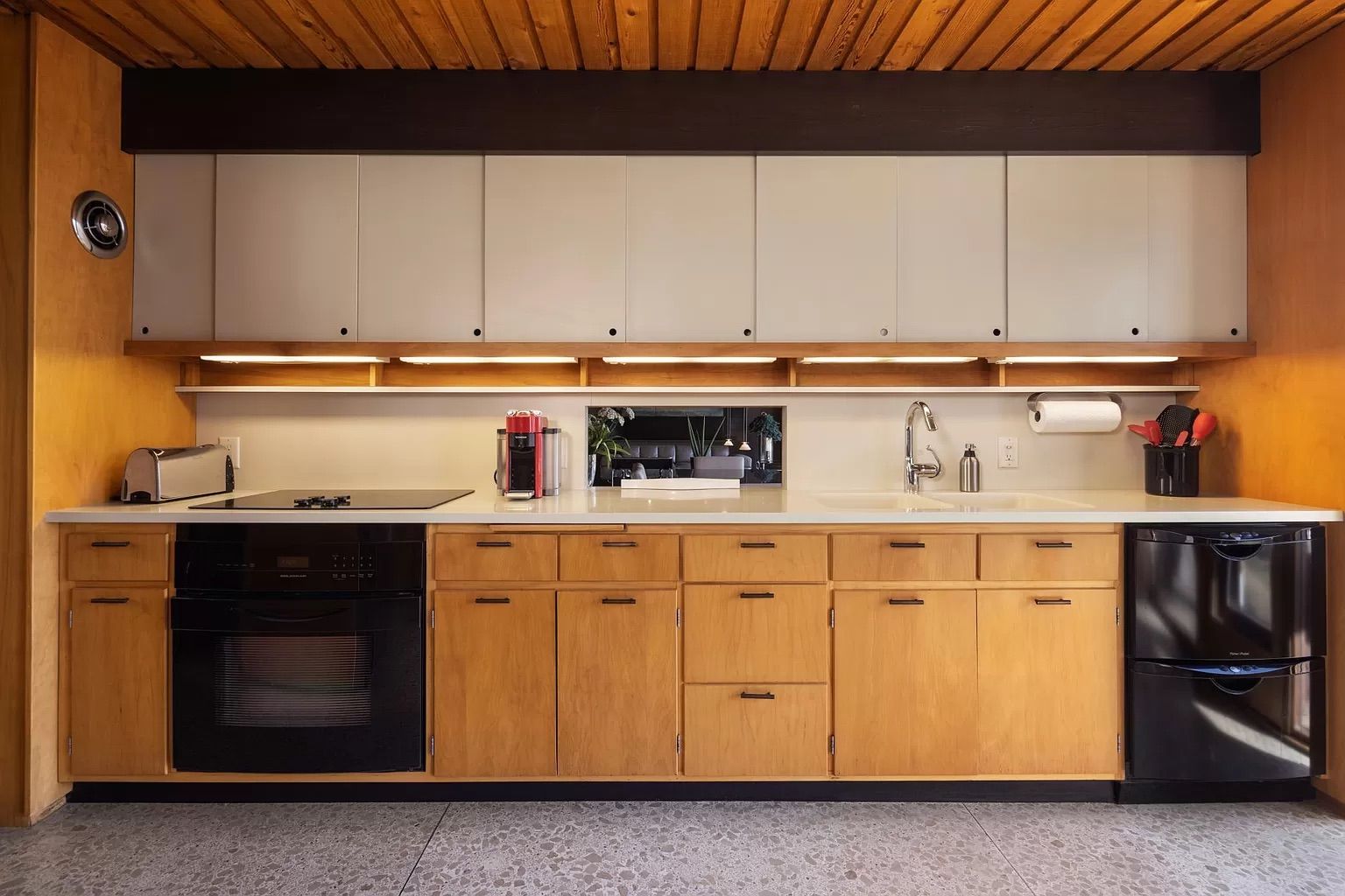A kitchen with white and wood cabinets.