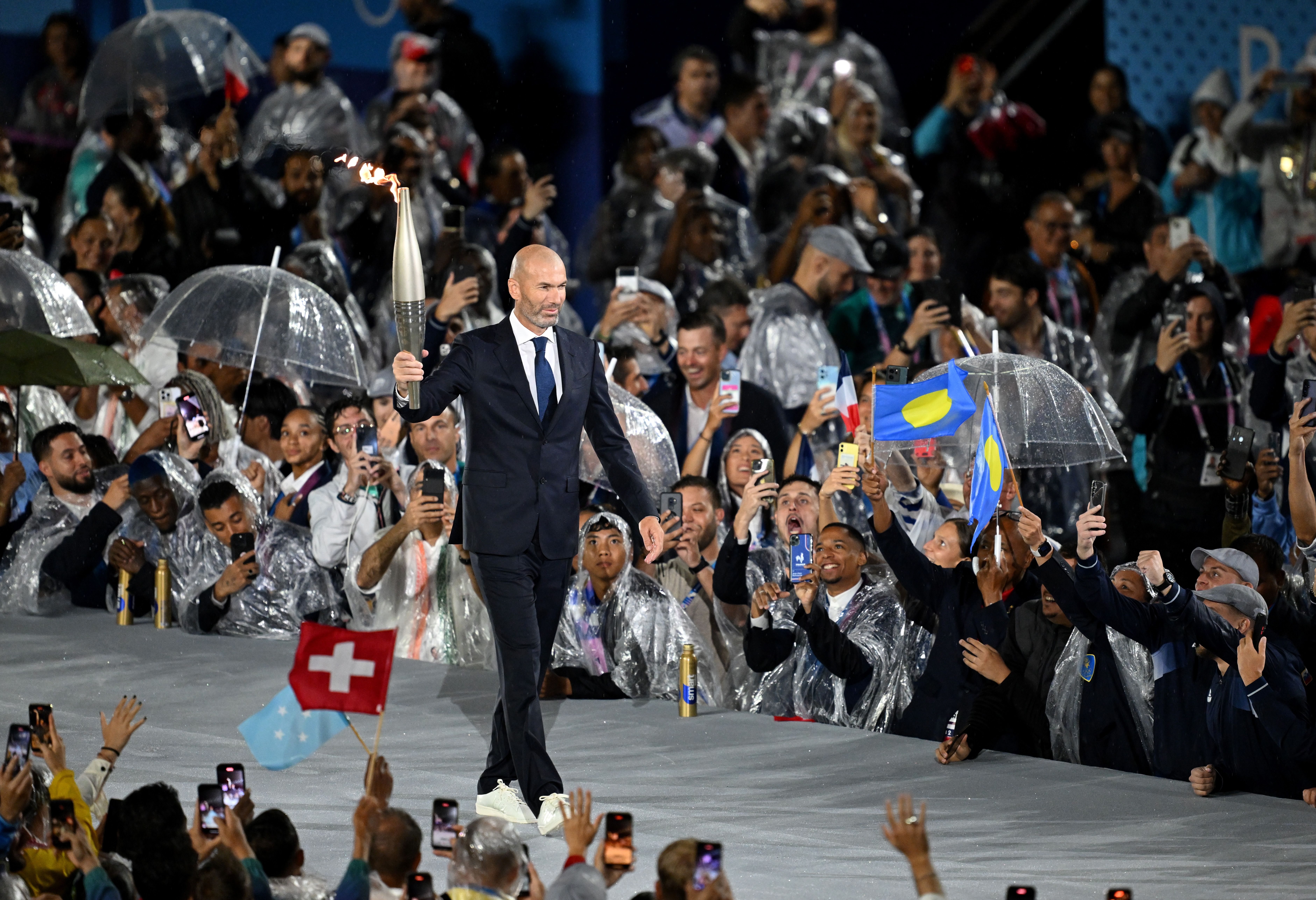 Zinedine Zidane carries the Olympic torch. Photo: Sven Hoppe/dpa (Photo by Sven Hoppe/picture alliance via Getty Images)