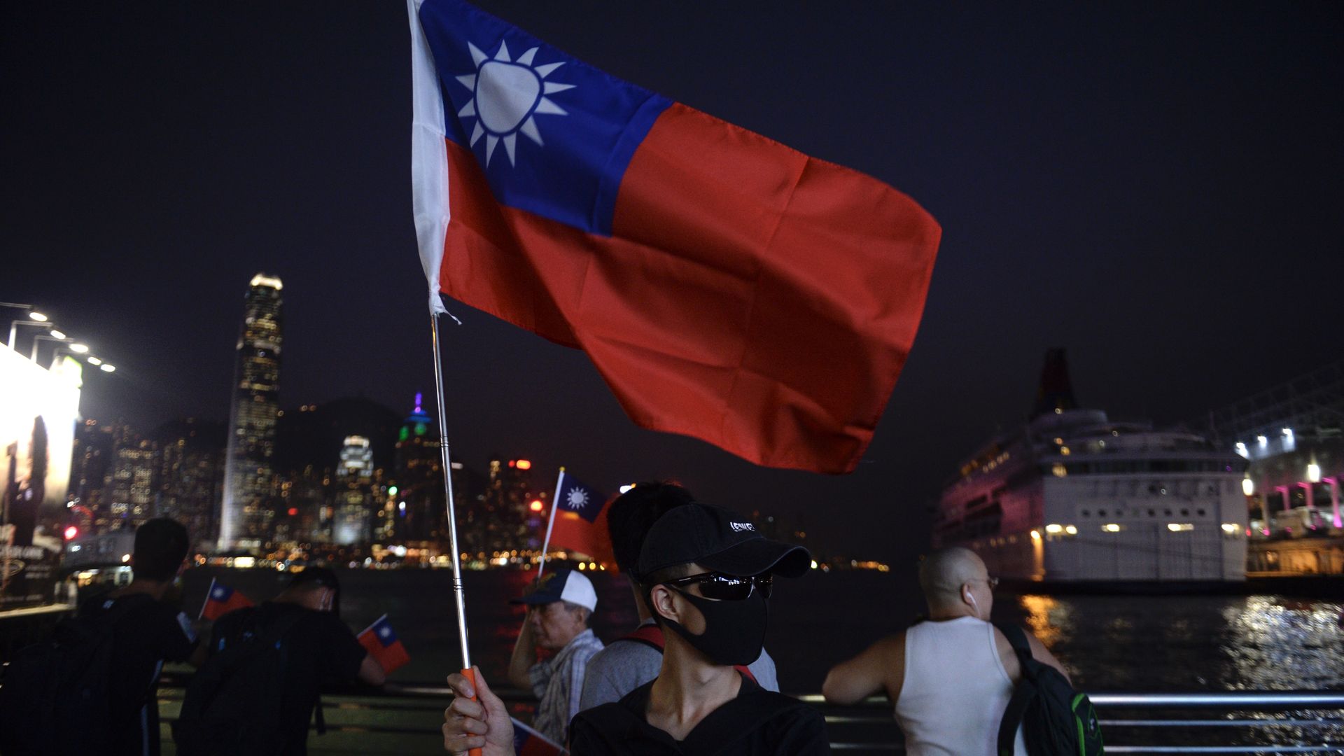 Man in mask holding Taiwan flag