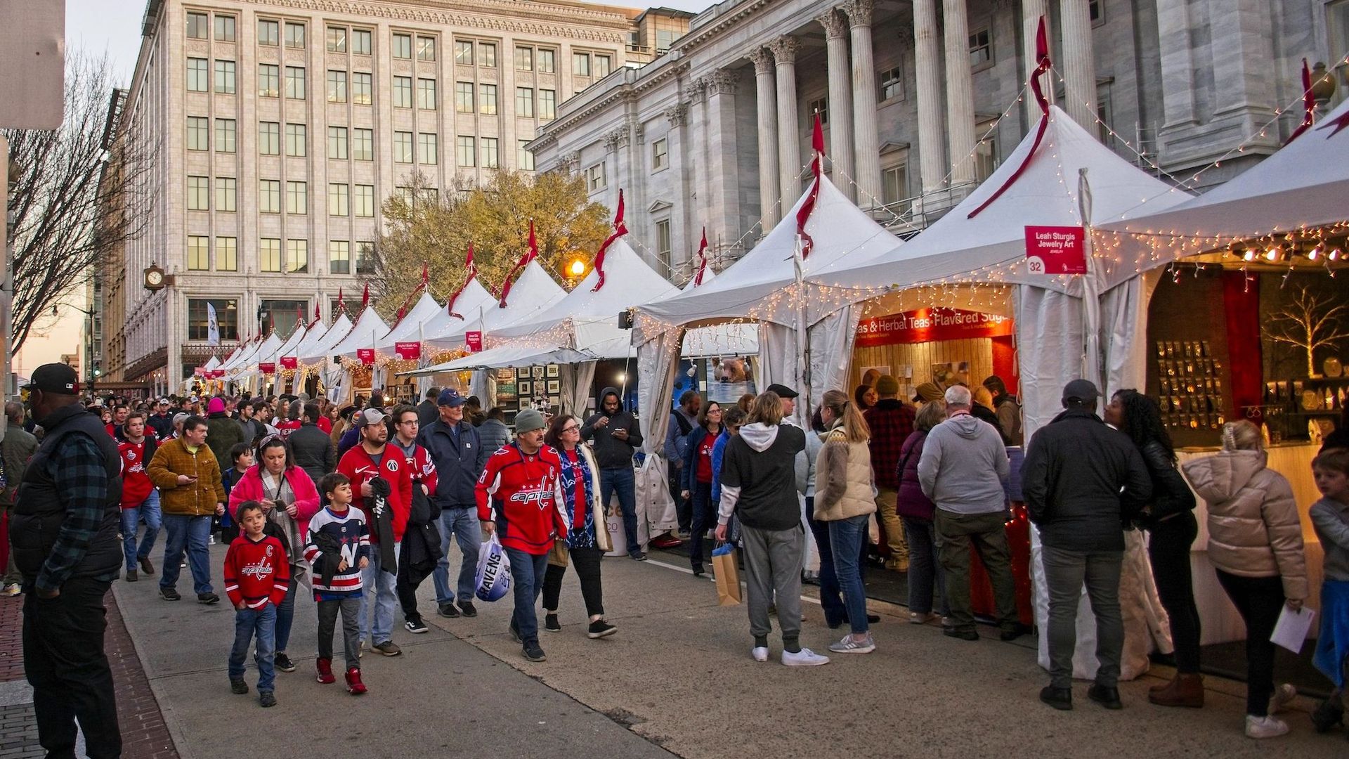 People walk through a holiday market in downtown DC