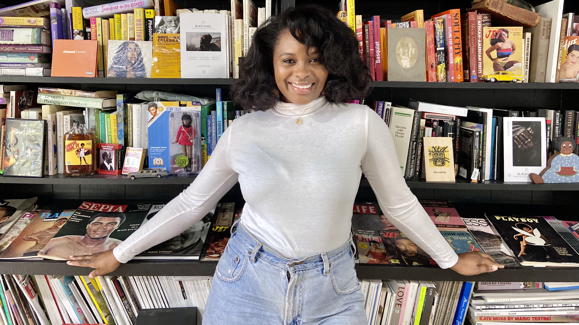 Archive owner Cheryse Terry in front of shelves of books