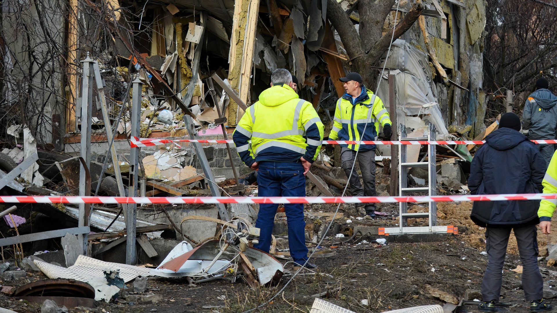 Rescuers examine a destroyed apartment building after a rocket attack by Russia in Kyiv. 