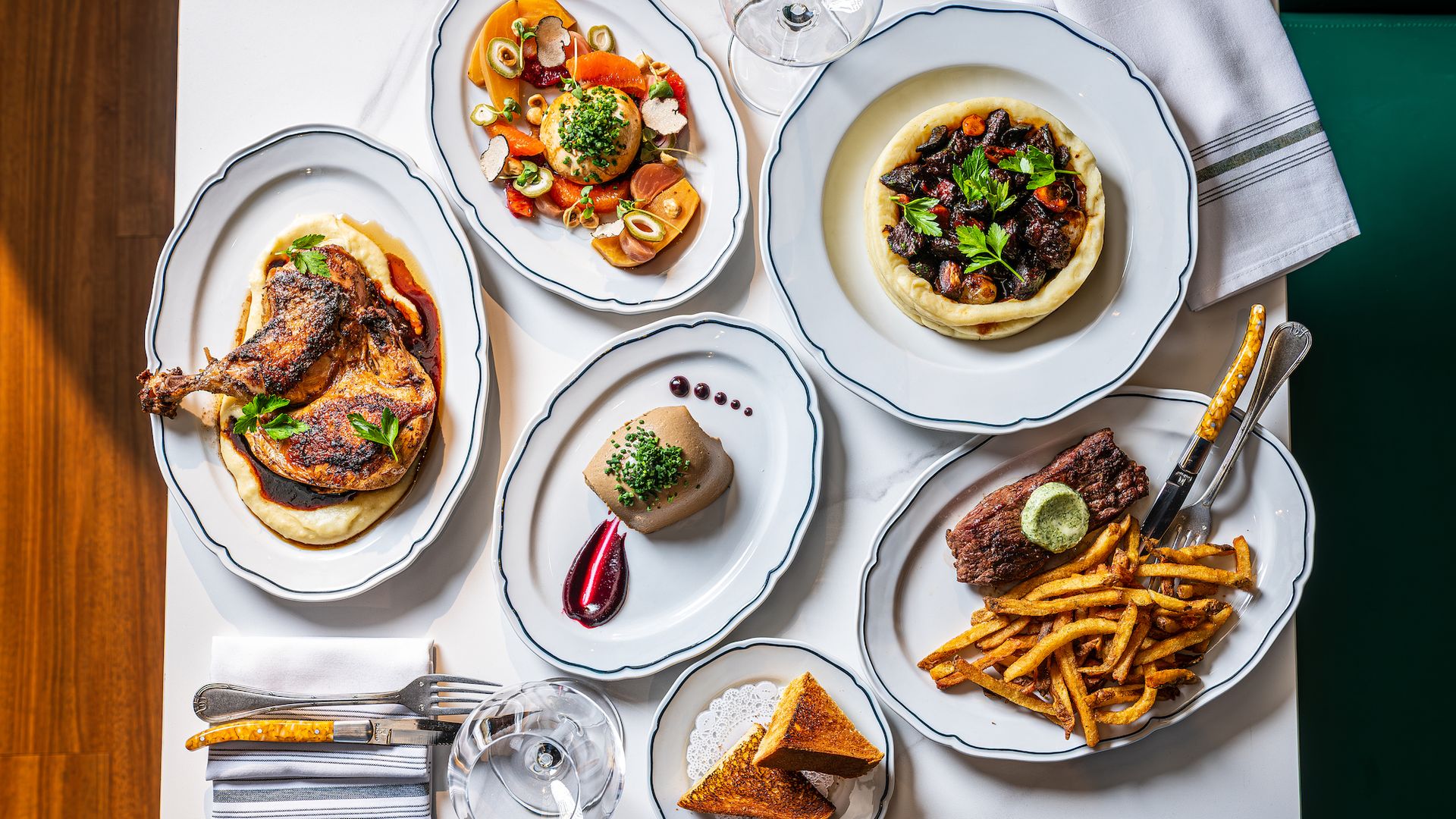 A table at Josephine brasserie with steak frites, roast chicken, foie gras mousse and more