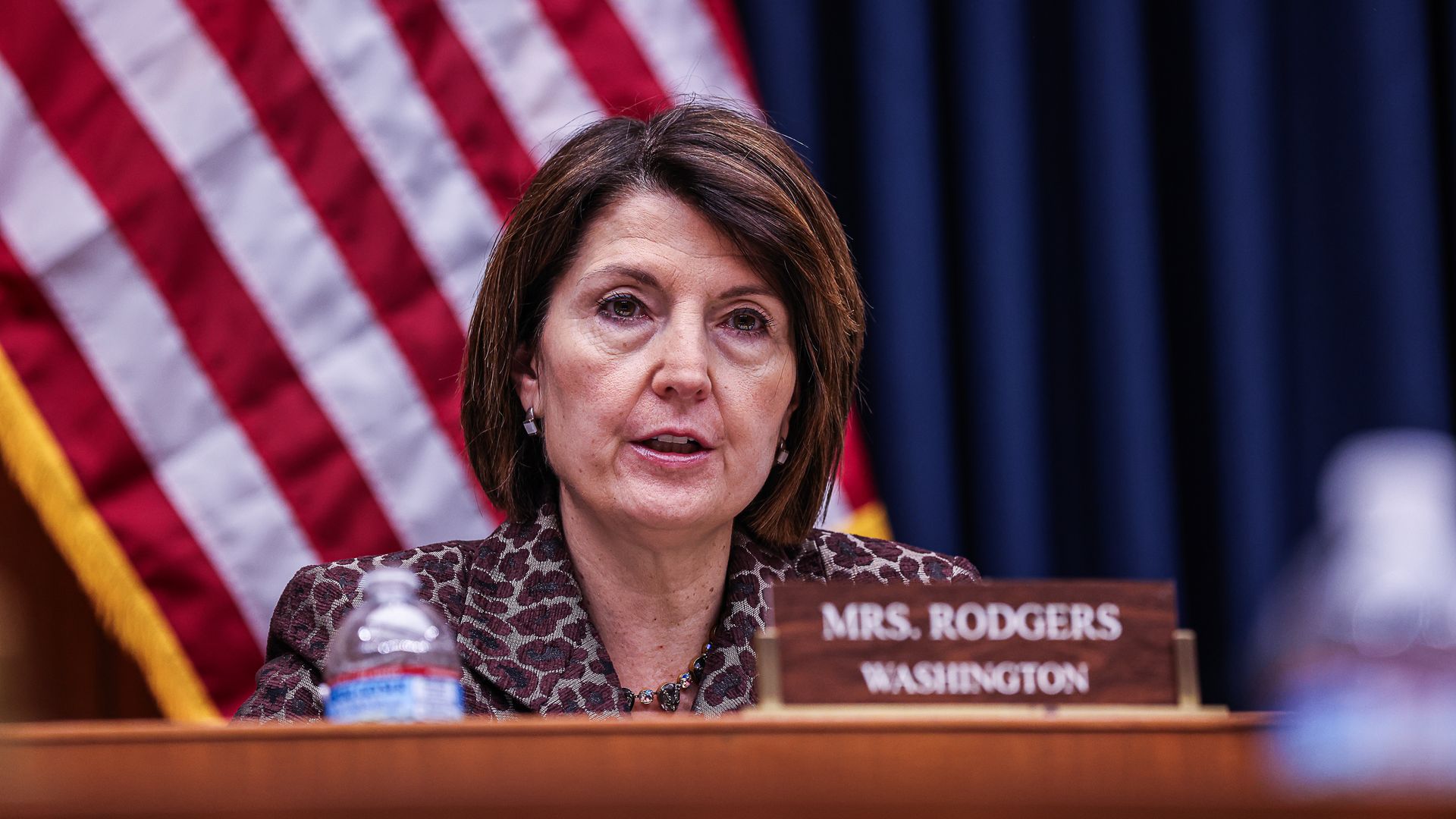 Rep. Kathy McMorris Rodgers, sitting behind a committee dais in front of an American flag.