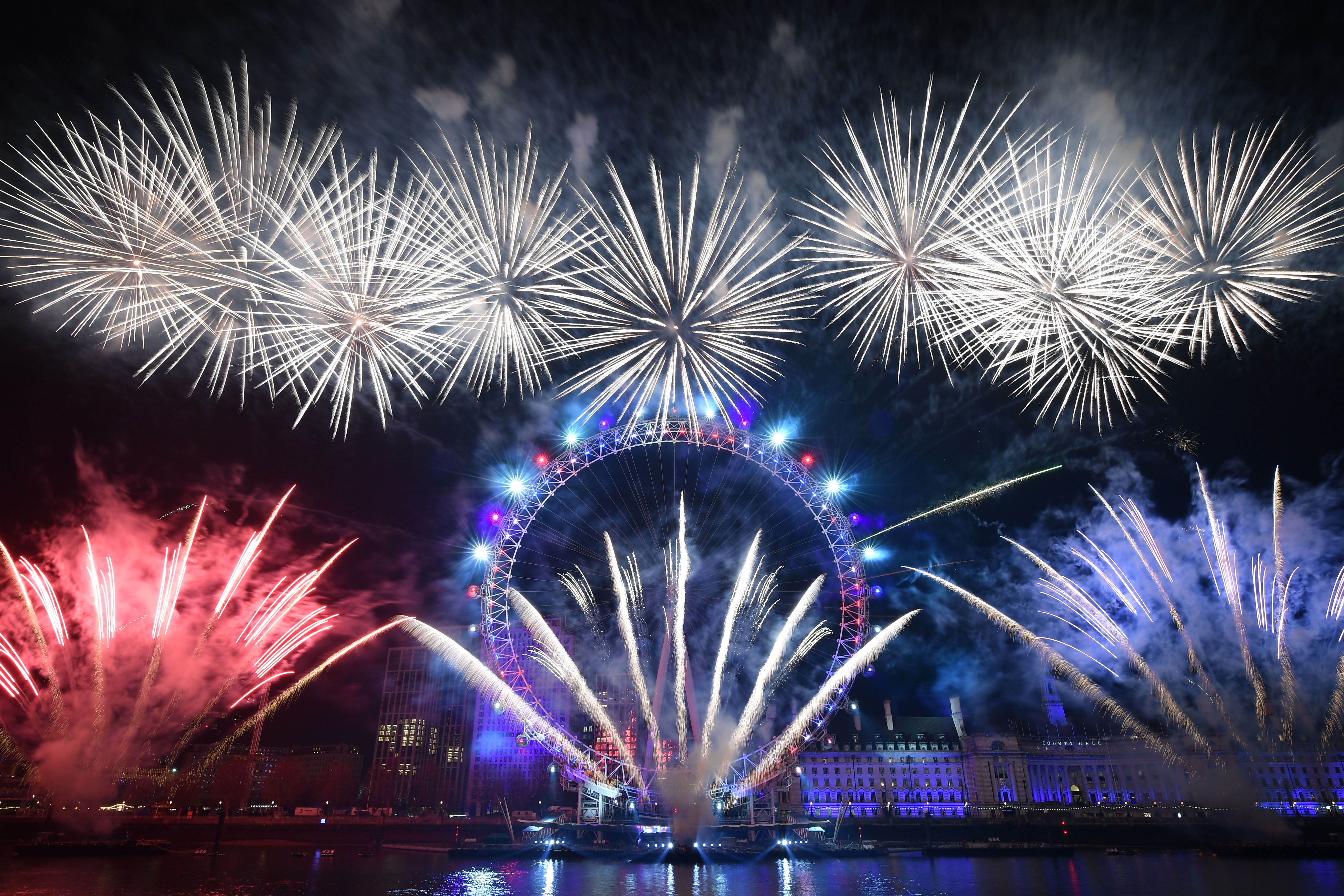 Fireworks explode around the London Eye during New Year's celebrations in central London just after midnight on January 1, 2020.