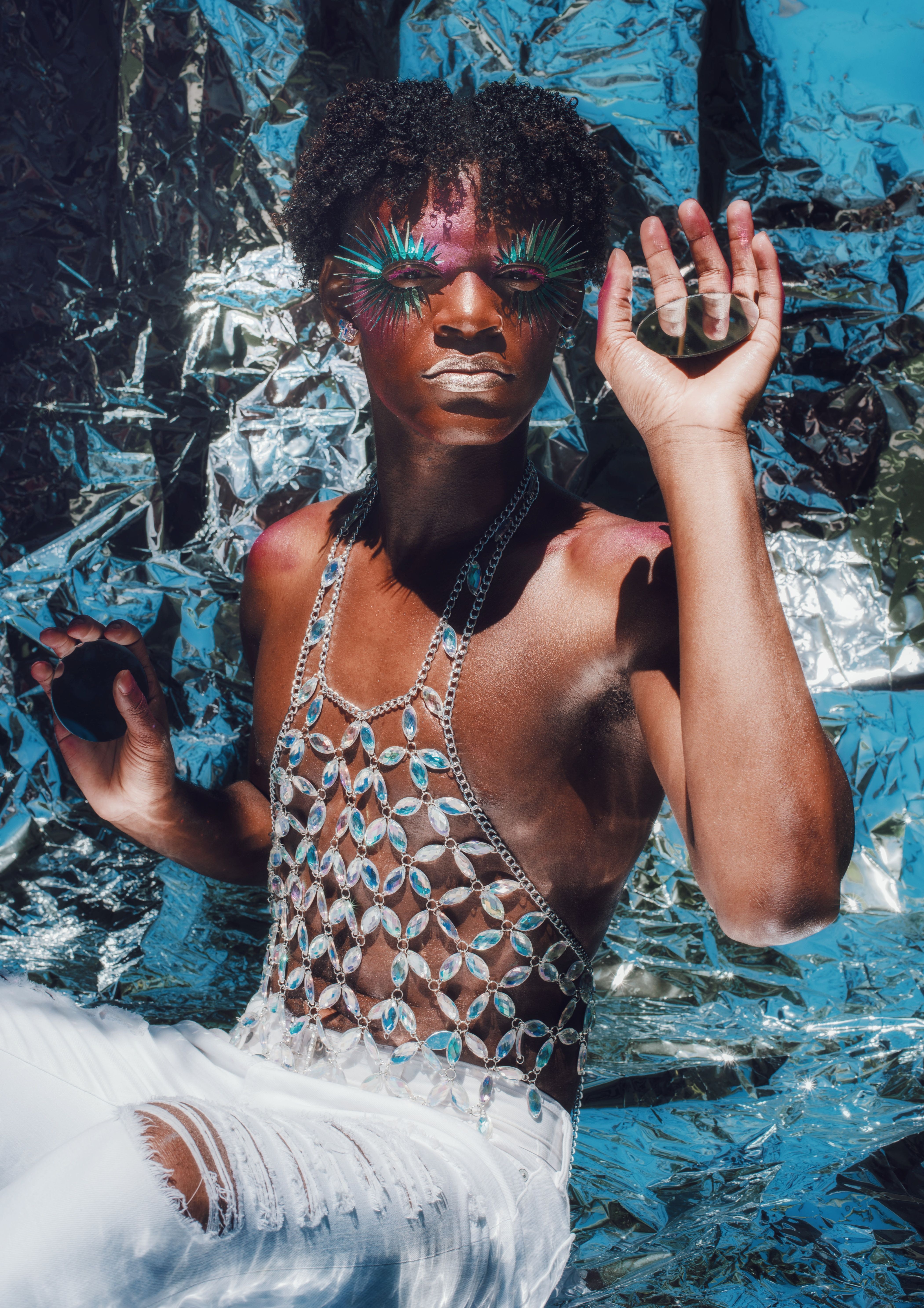 Photo of a man in a bedazzled costume and colorful eye makeup