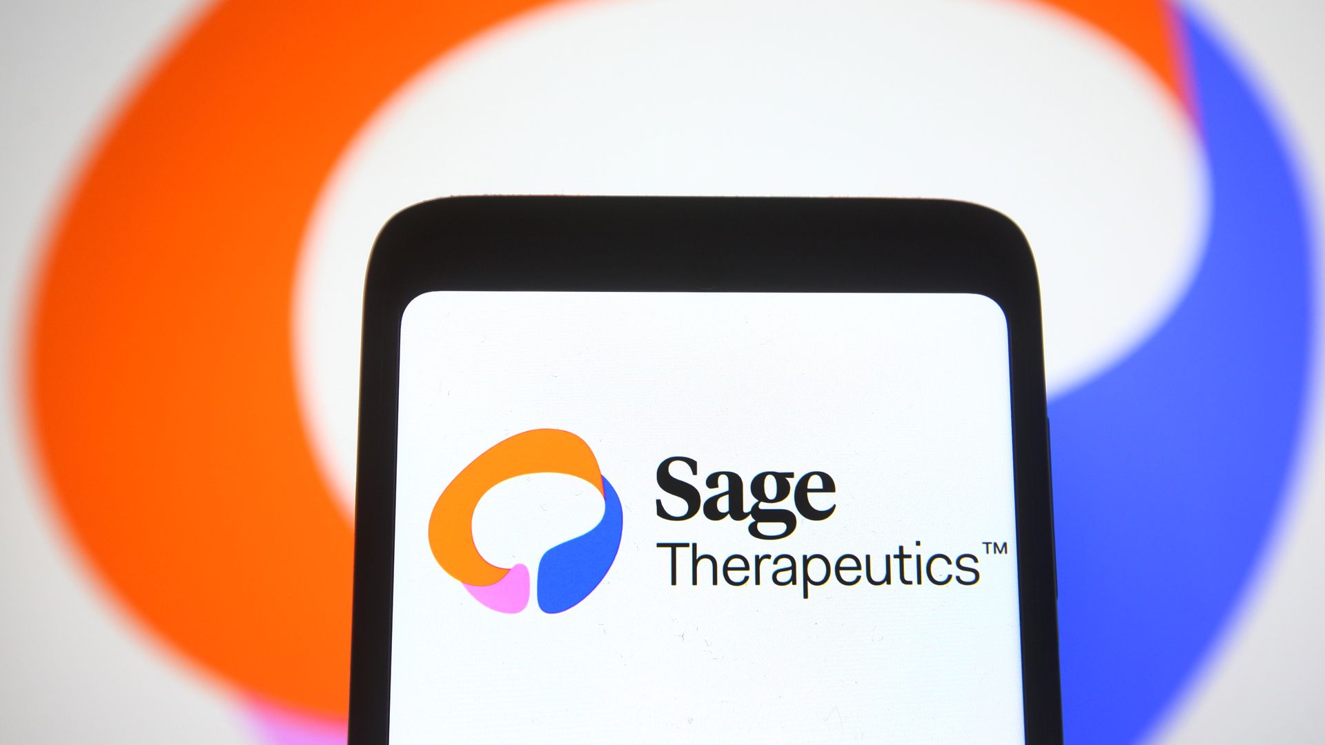 Photo illustration of Sage Therapeutics logo on a smartphone.