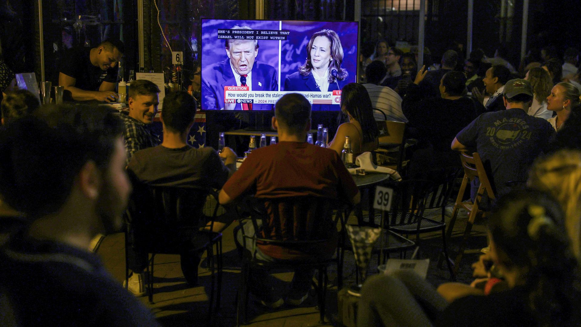 People in D.C. watch the debate at a bar outdoors
