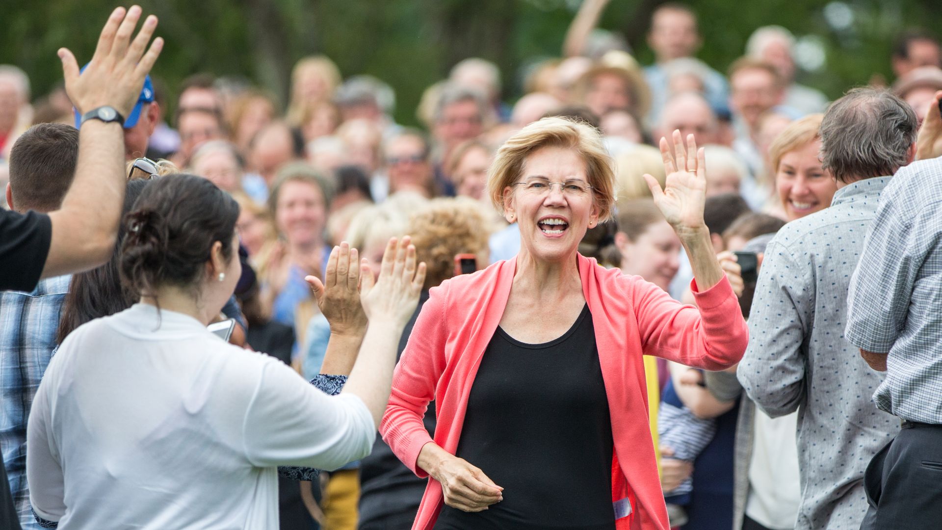 Sen. Elizabeth Warren waves at a Labor Day house party.