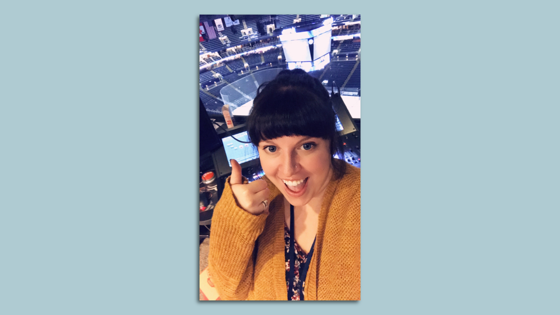 Becca Golden gives a thumbs up inside the Nationwide Arena lighting and sound booth. 