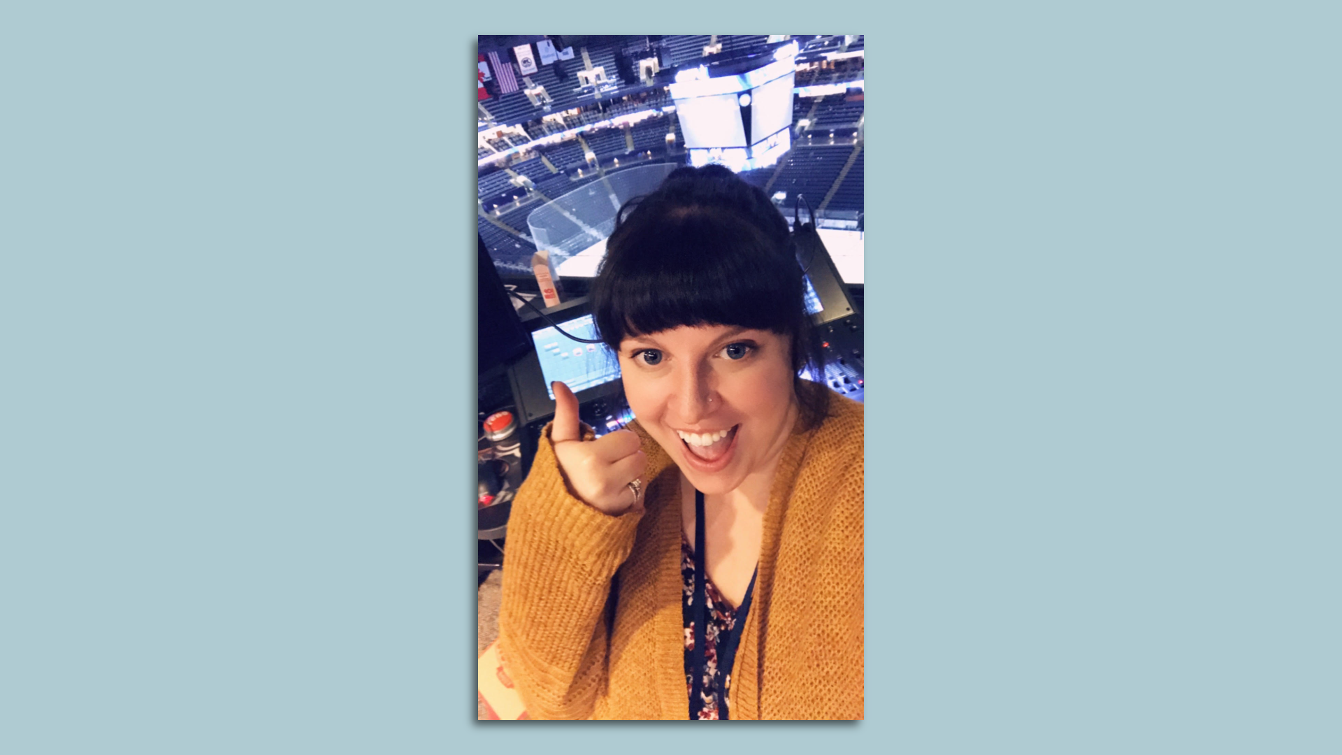 Becca Golden gives a thumbs up inside the Nationwide Arena lighting and sound booth.