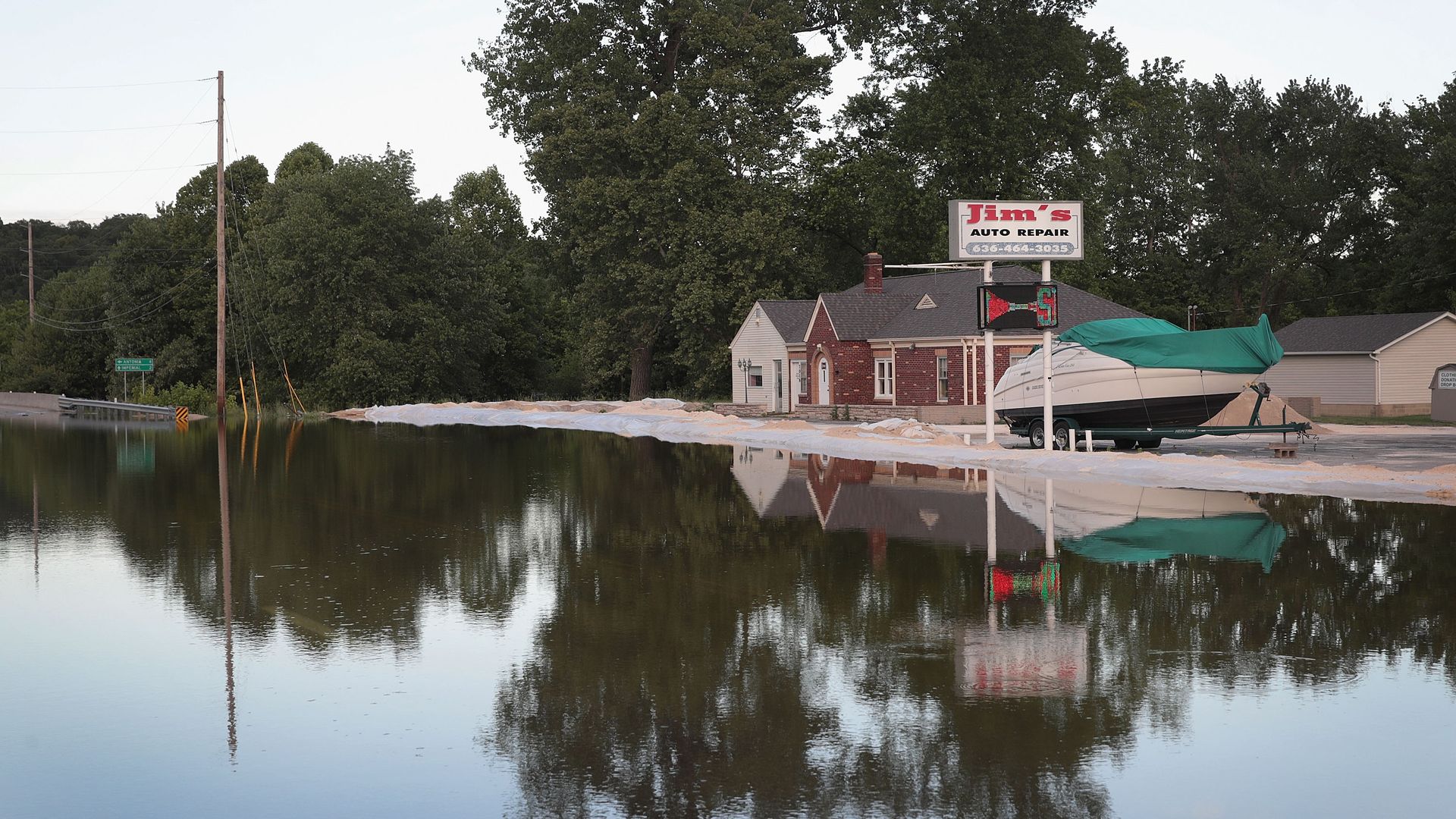 This image shows a small shop surrounded by floodwater.