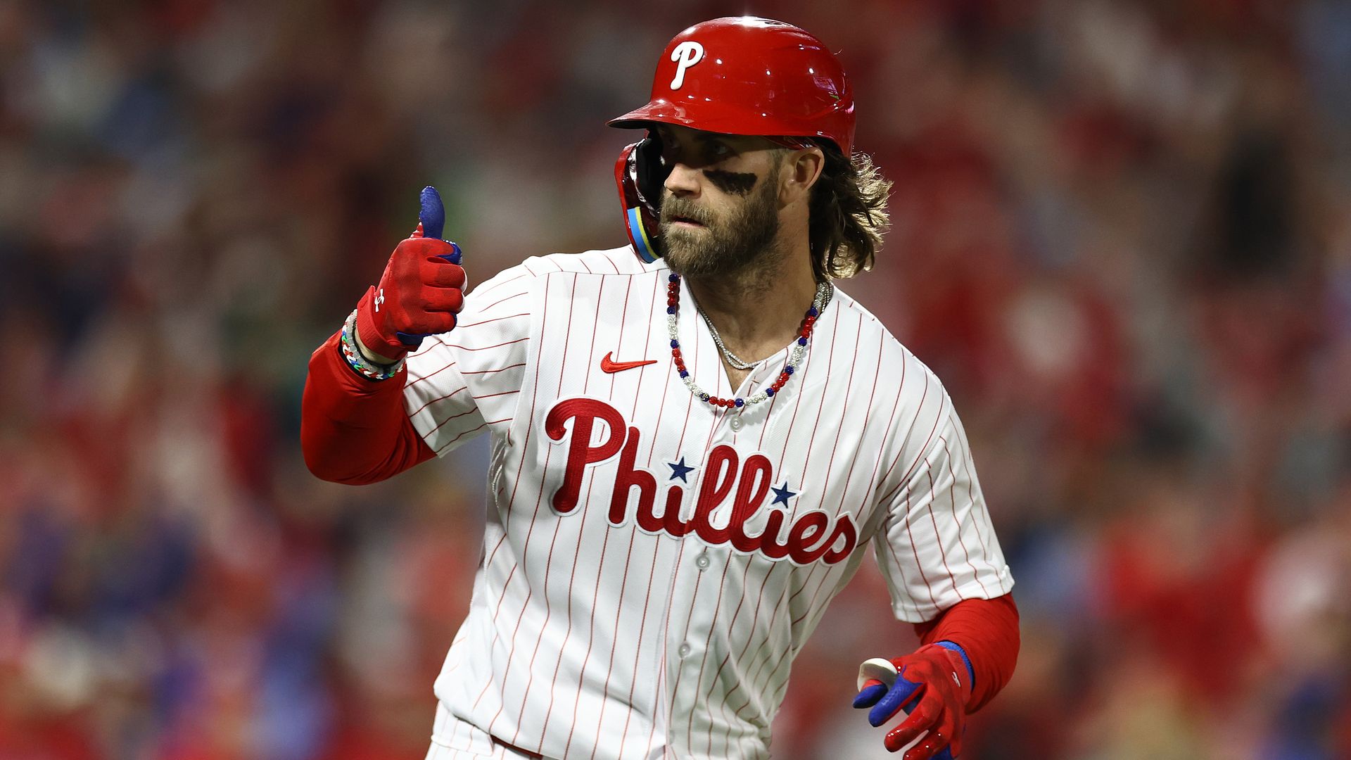 The Phillies Bryce Harper gives a thumbs up during a game.