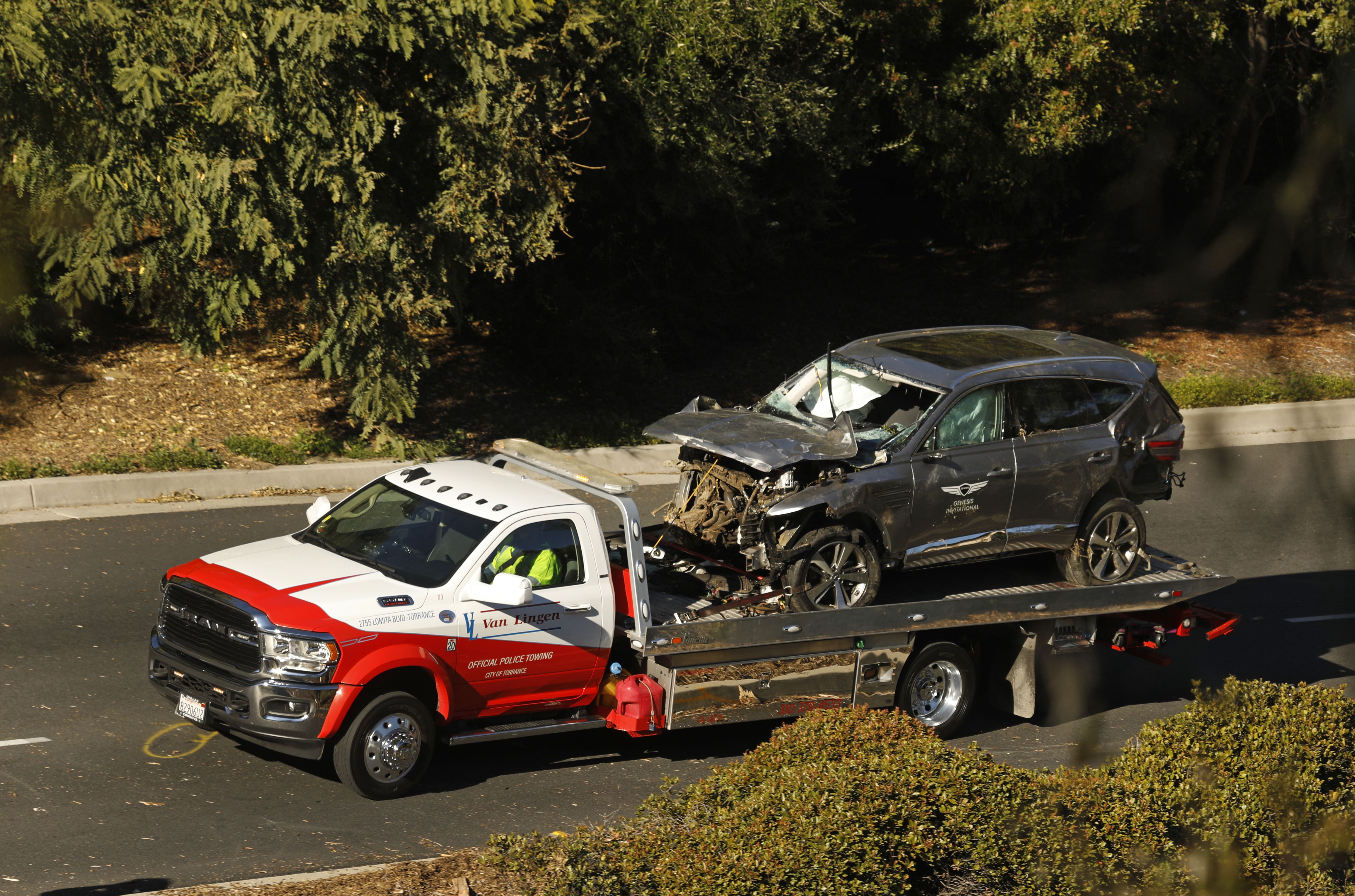 Tiger Woods' car being carried by a truck.