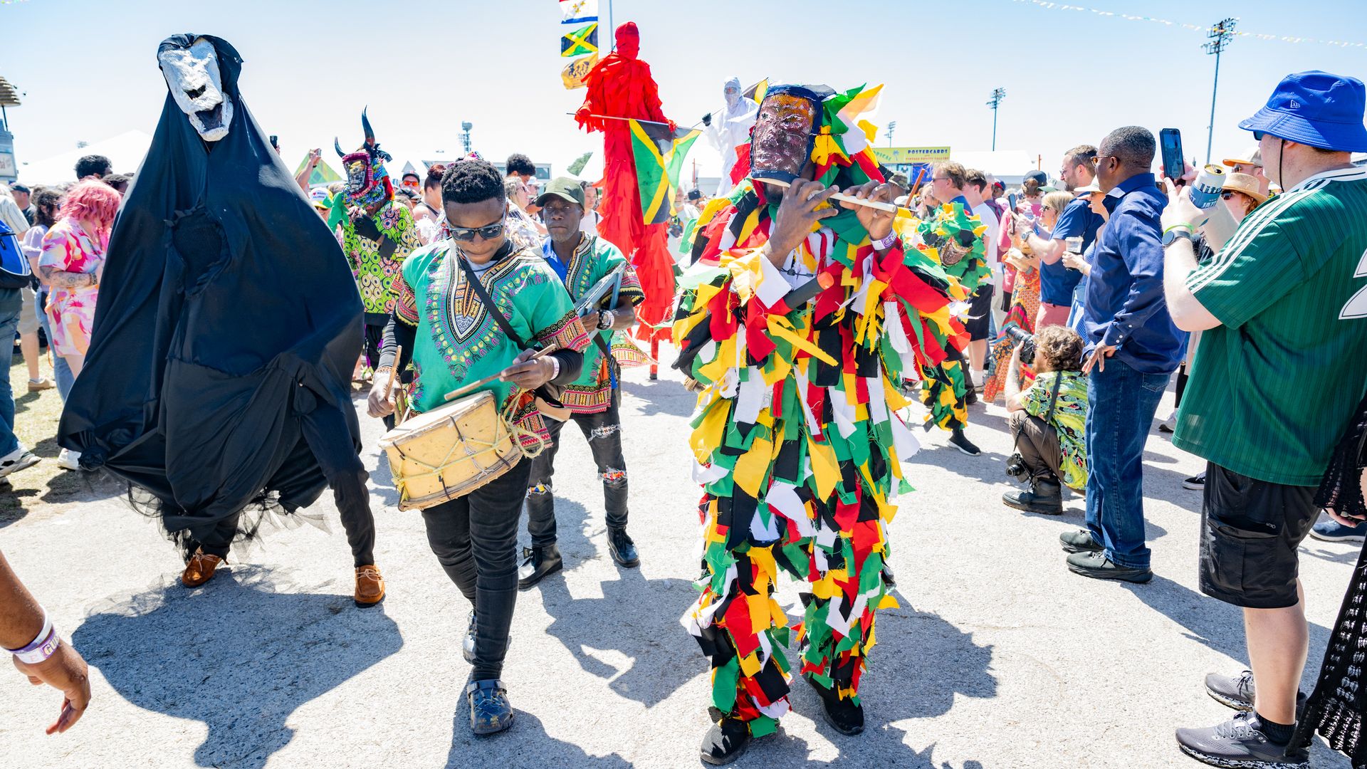 The Jamaican Parade with Kaya Jonkunnu Band and Walking Tall Jamaica moves through Fair Grounds Race Course.