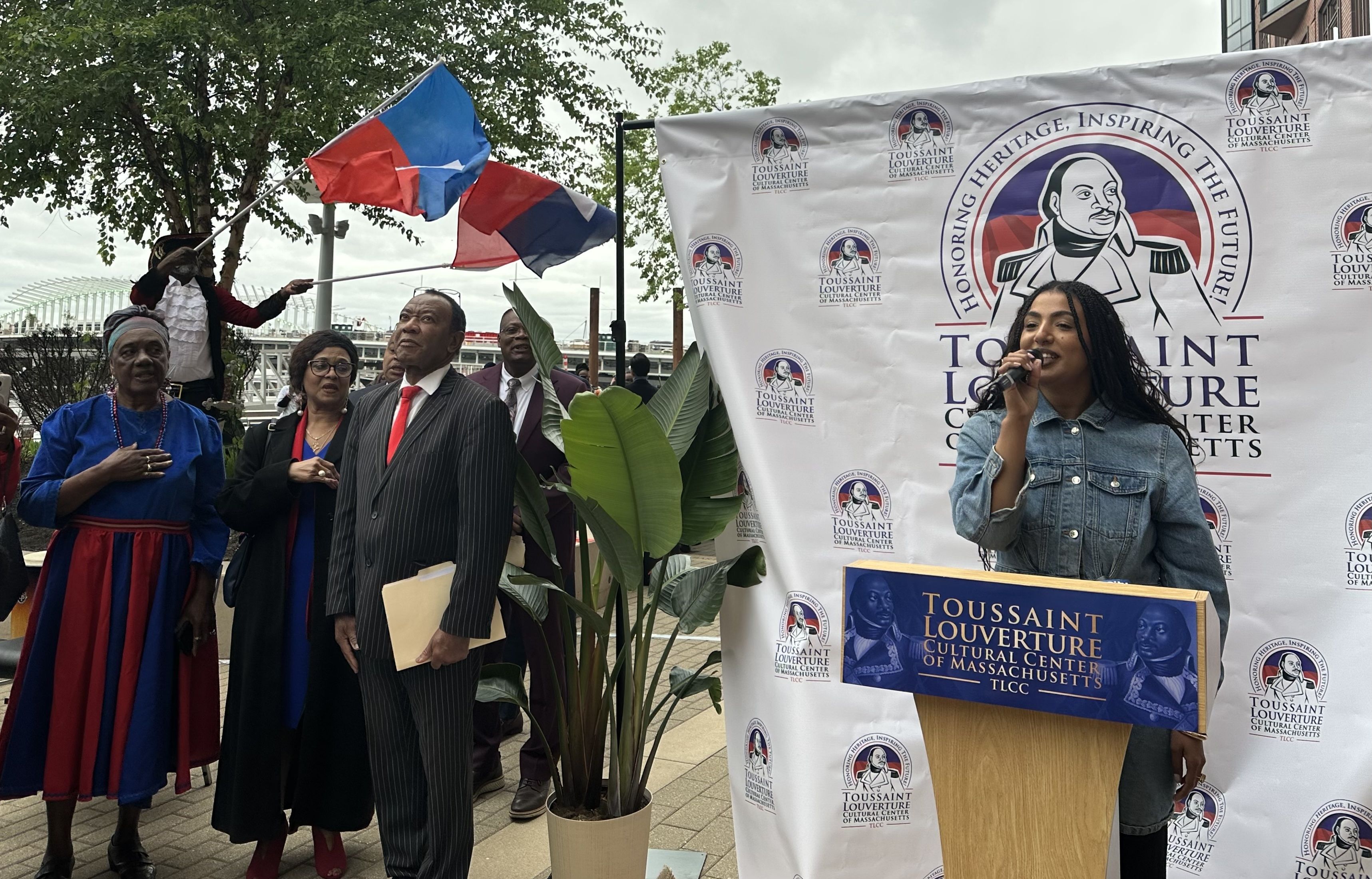 Boston singer Rebecca Zama sang the American and Haitian national anthems to scores of attendees at Lovejoy Wharf.