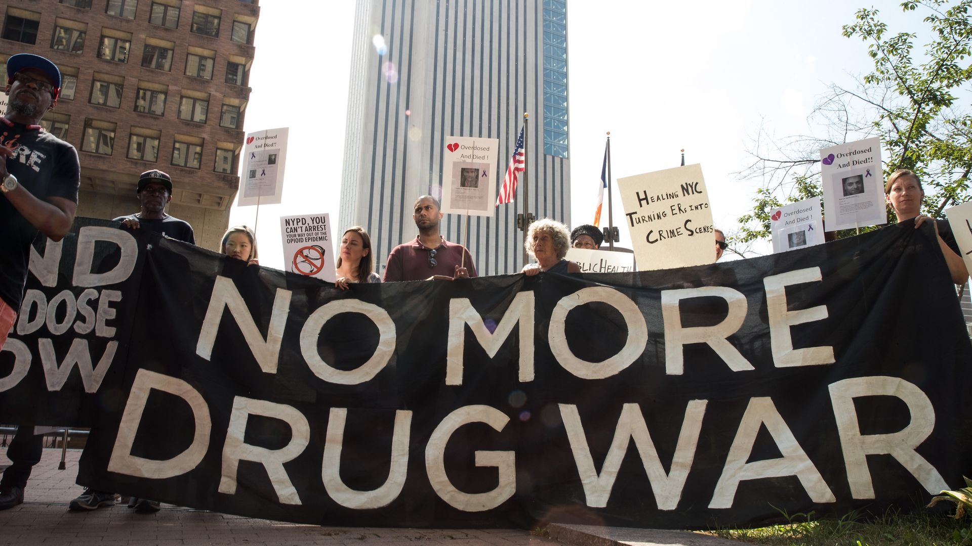 Activists hold a sign that reads, "No more drug war"