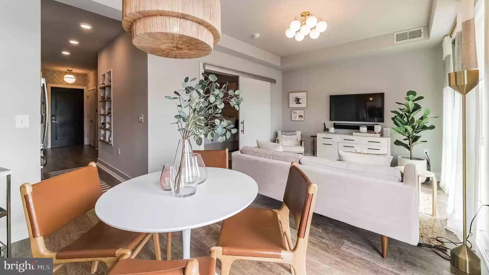 dining and living area with attractive light fixtures 