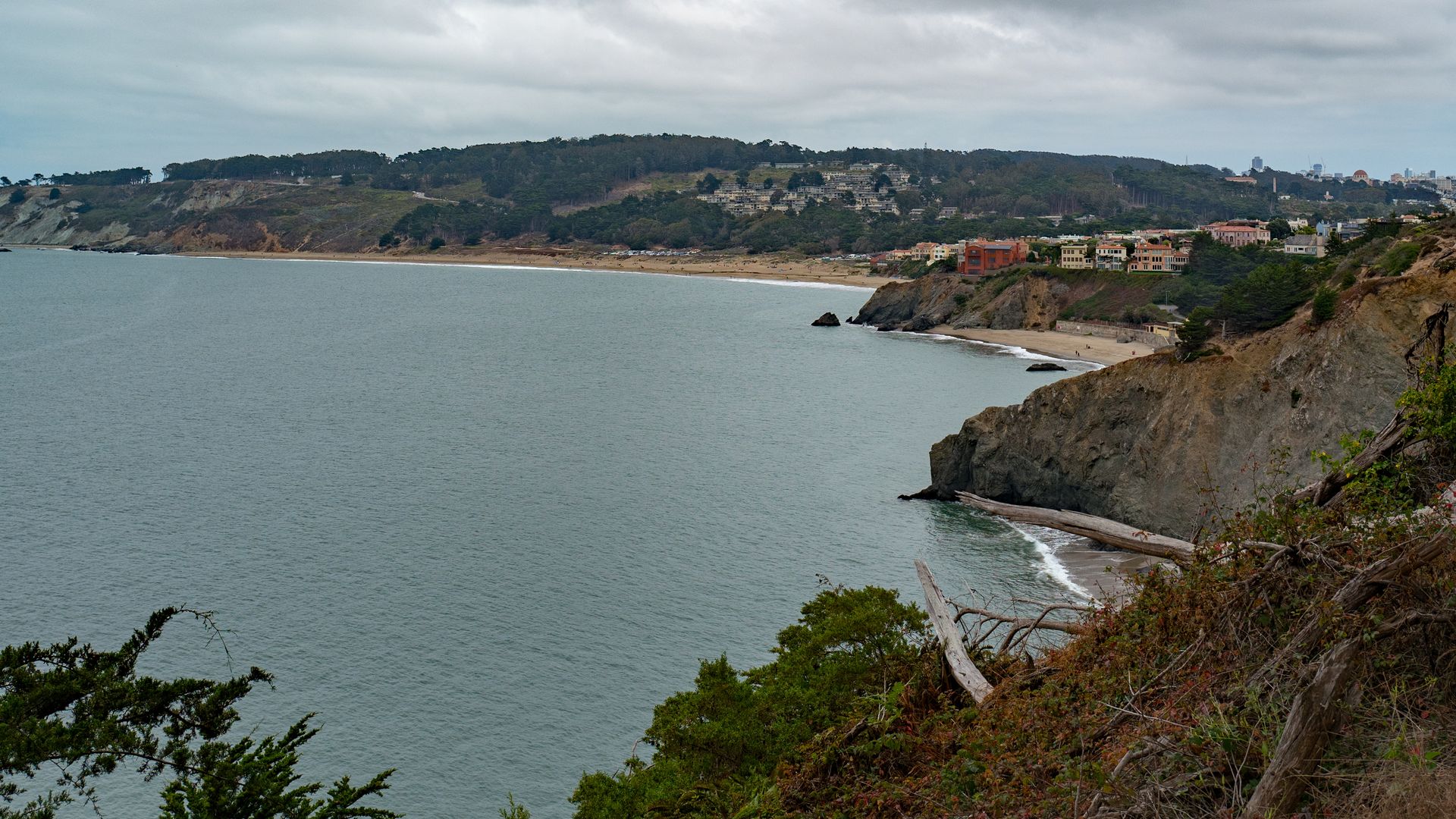 Photo of the coastline and a beach tucked in between the cliffs