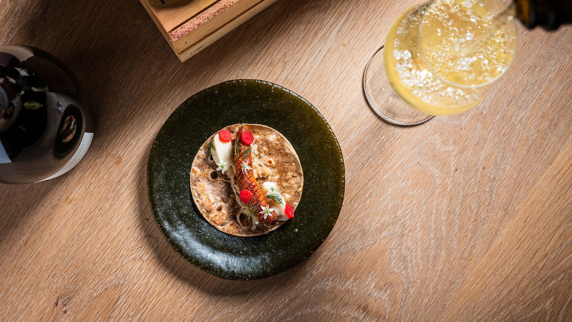 A plate made from crushed bottles at Oyster Oyster, served with Champagne