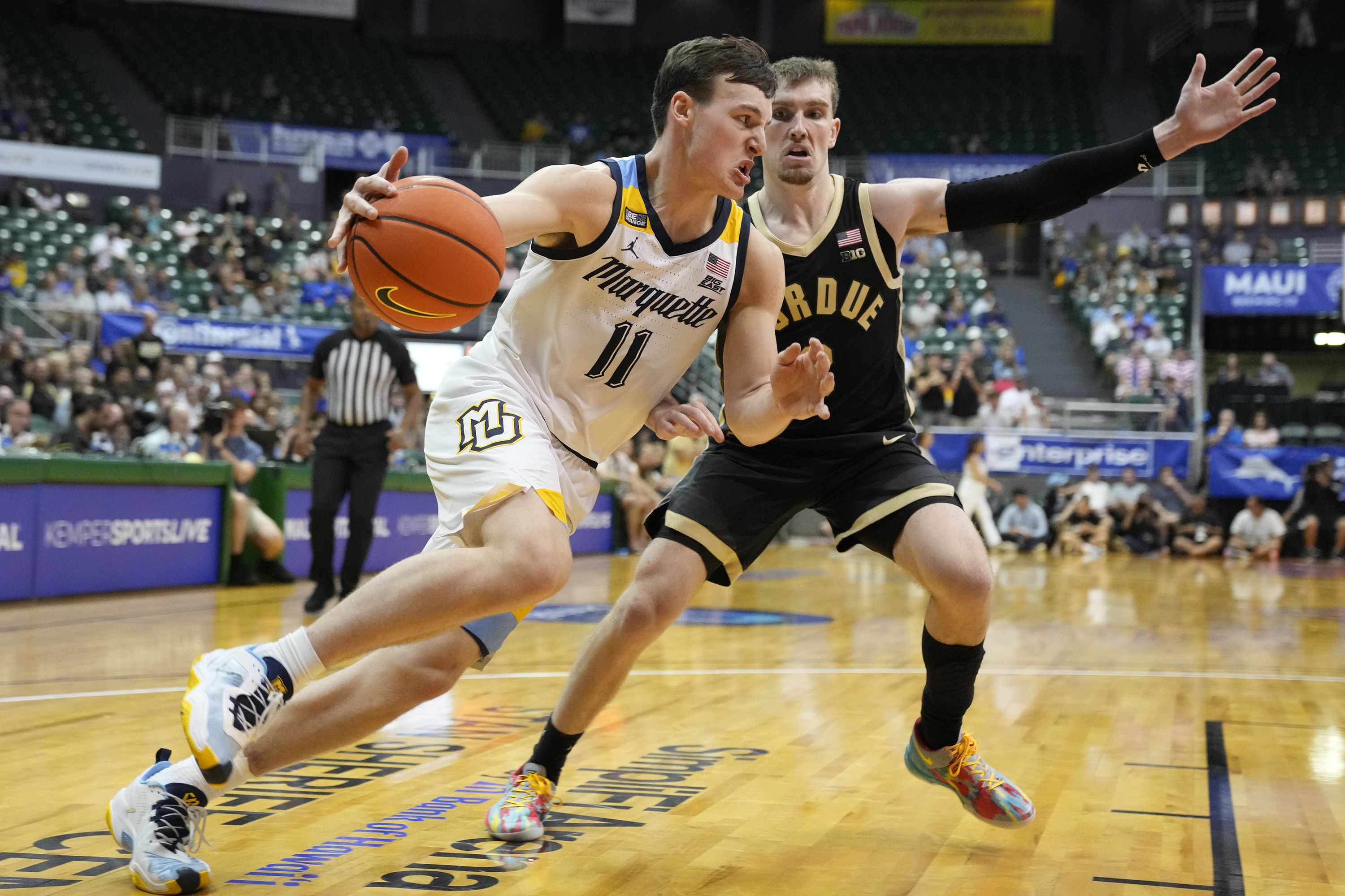Photo of a basketball. player with a ball driving to the hoop 
