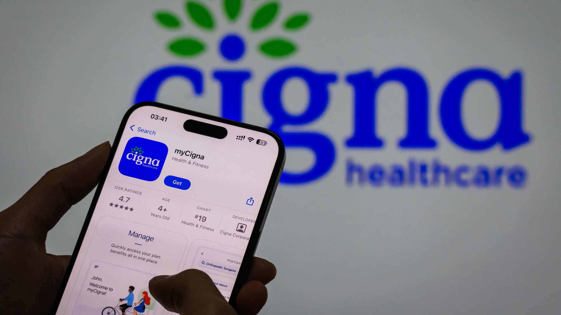 An image of the Cigna app in front of the Cigna logo. 