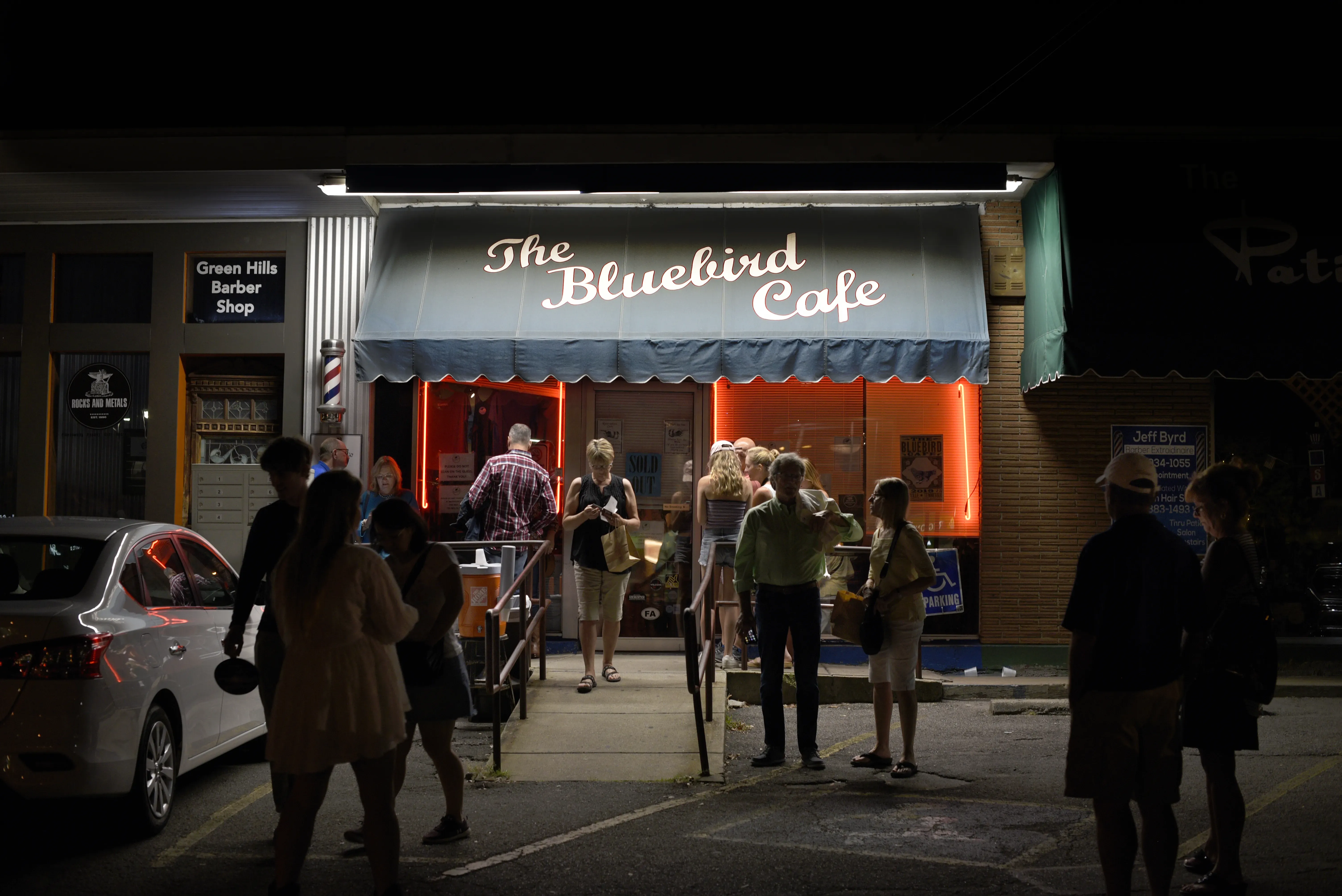 A line of fans standing outside the Bluebird Cafe.