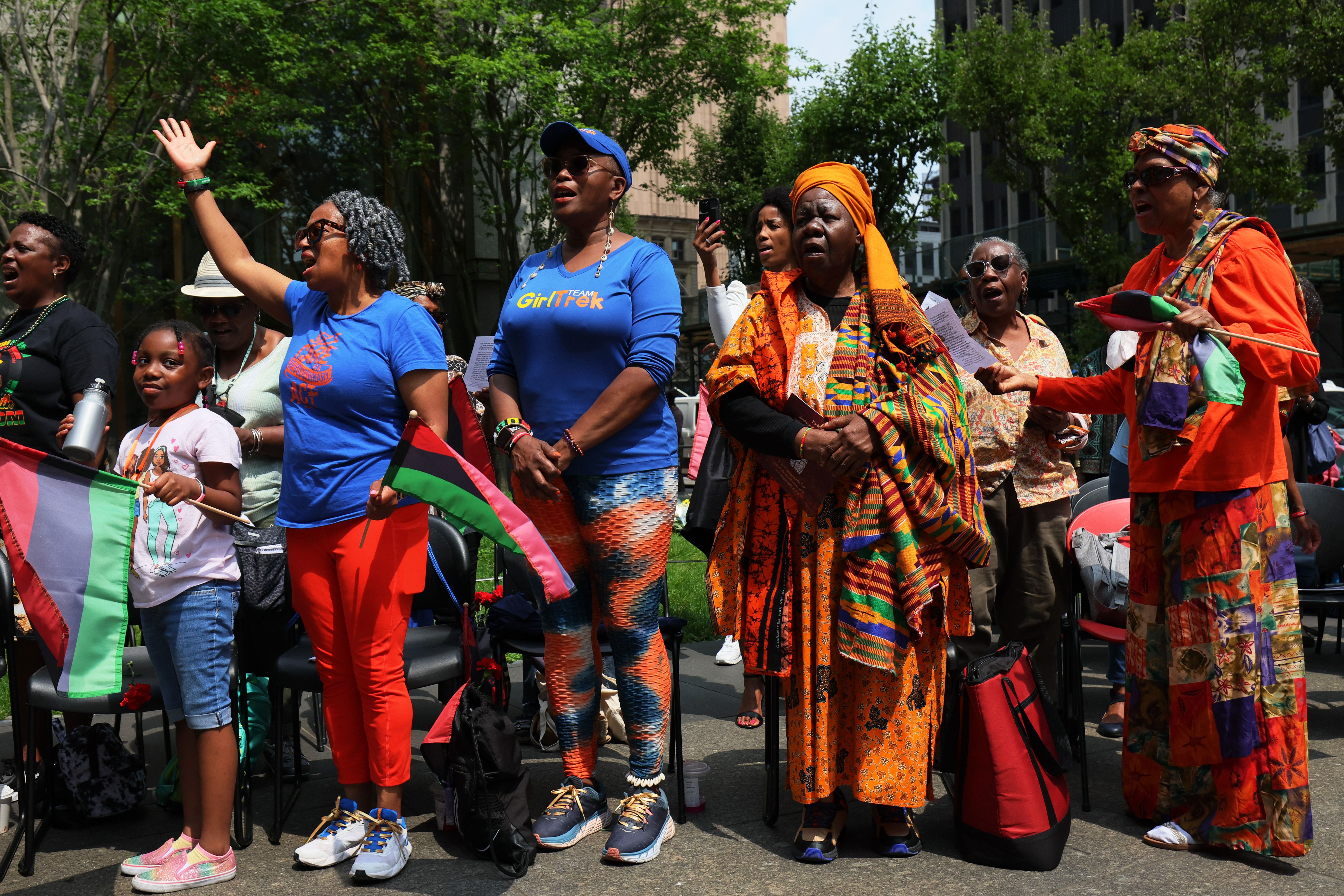  People sing "Lift Every Voice and Sing" during a Juneteenth celebration in New York City at the African Burial Ground National Monument on June 19, 2023 in New York City. A Juneteenth celebration was held at the Monument, where the remains of more than 419 Africans are buried, that featured a libation, drumming, speakers, and performances. 