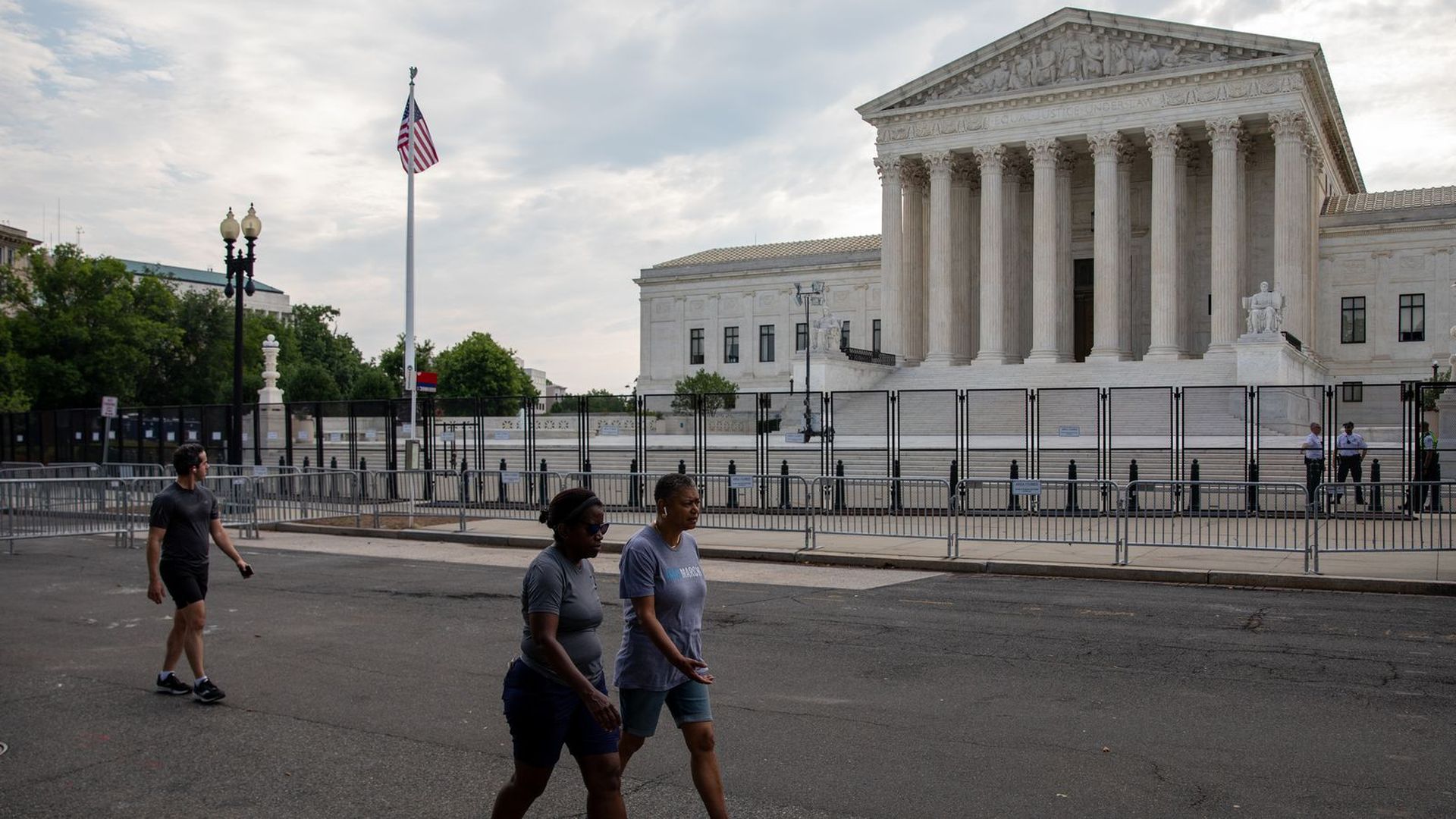 Pedestrians walk past the Supreme Court Building.