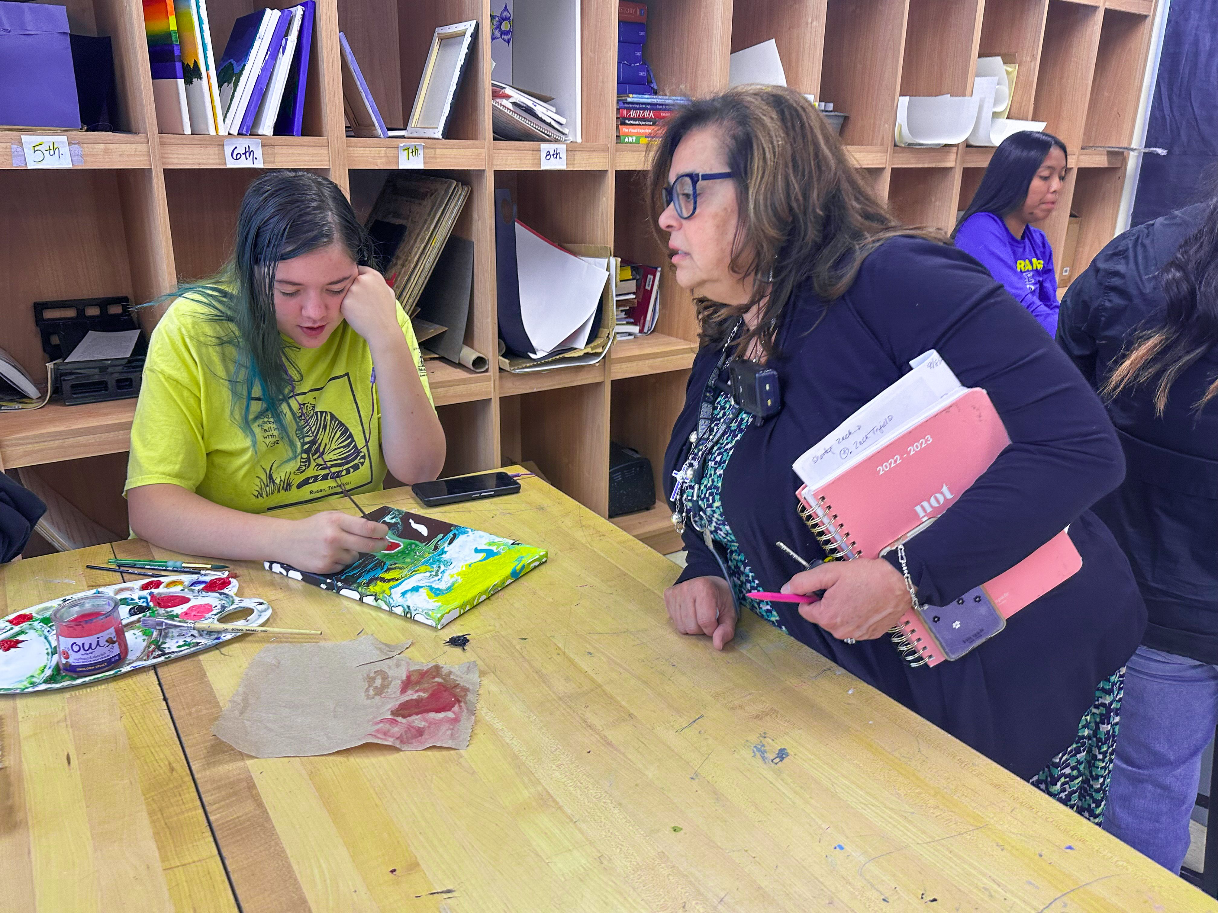 Cuba Superintendent Karen Sanchez-Griego asks a Cuba High School student about her art.