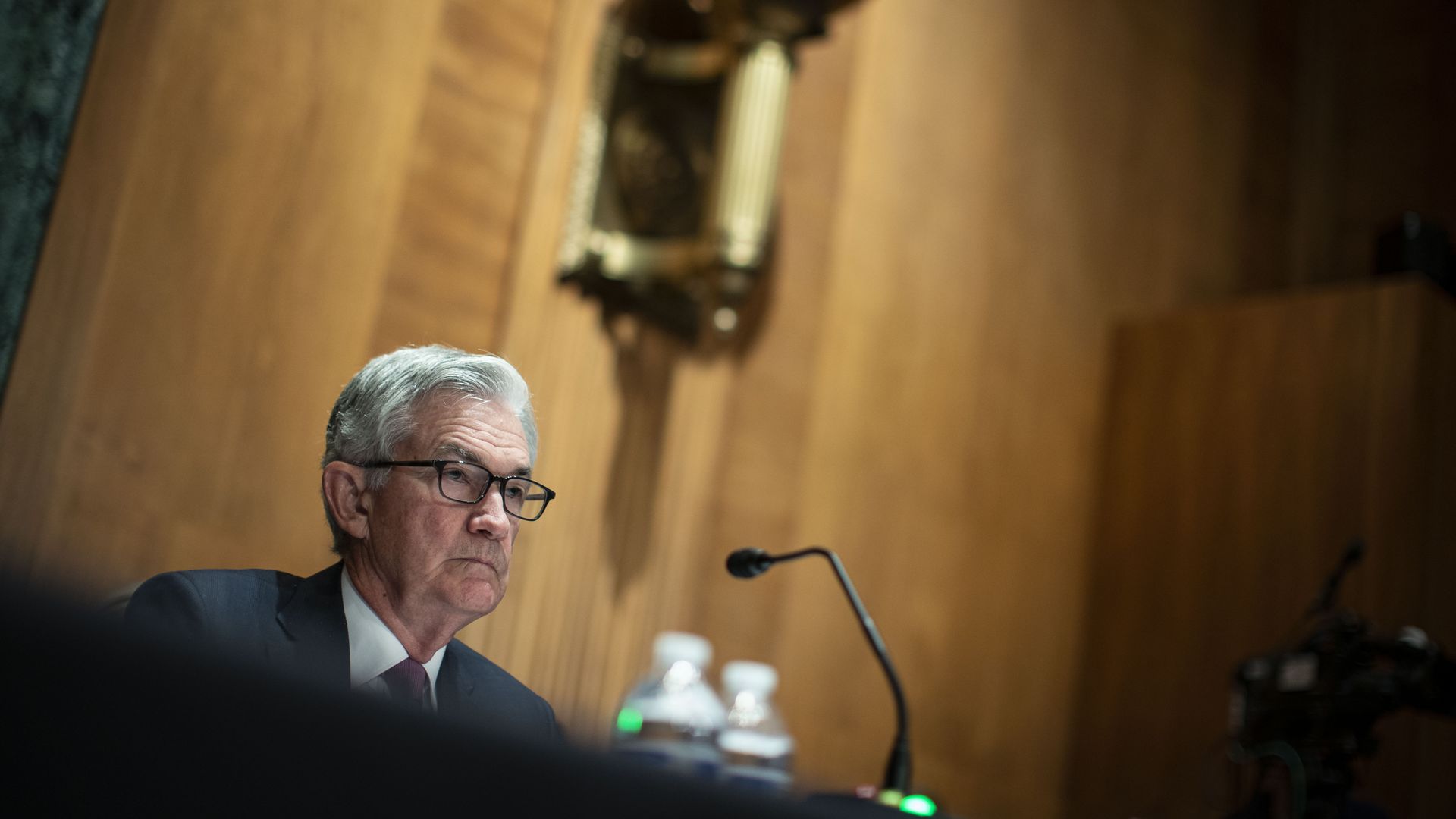 Photo of Jerome Powell sitting at a table before a mic