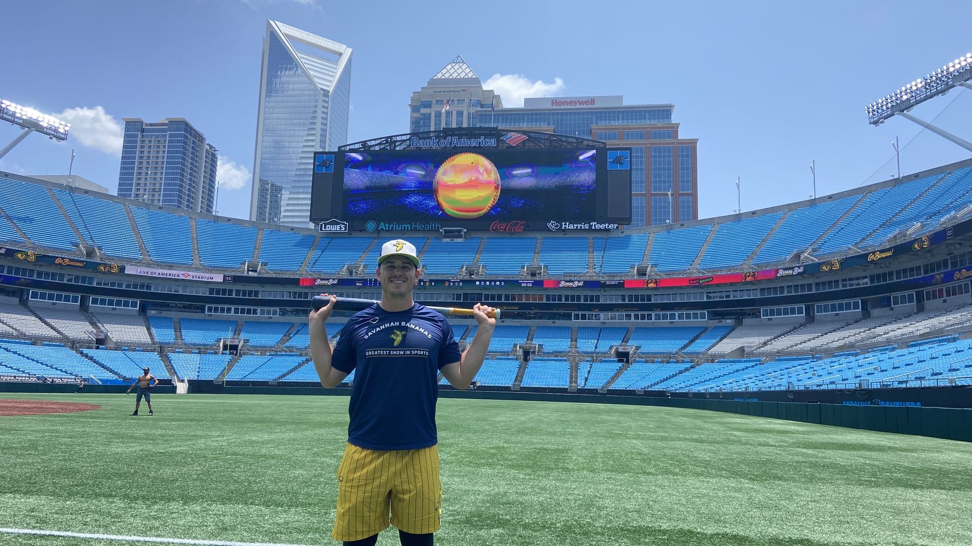 Eric Jones poses at Bank of America Stadium in front of the Charlotte Skyline. 
