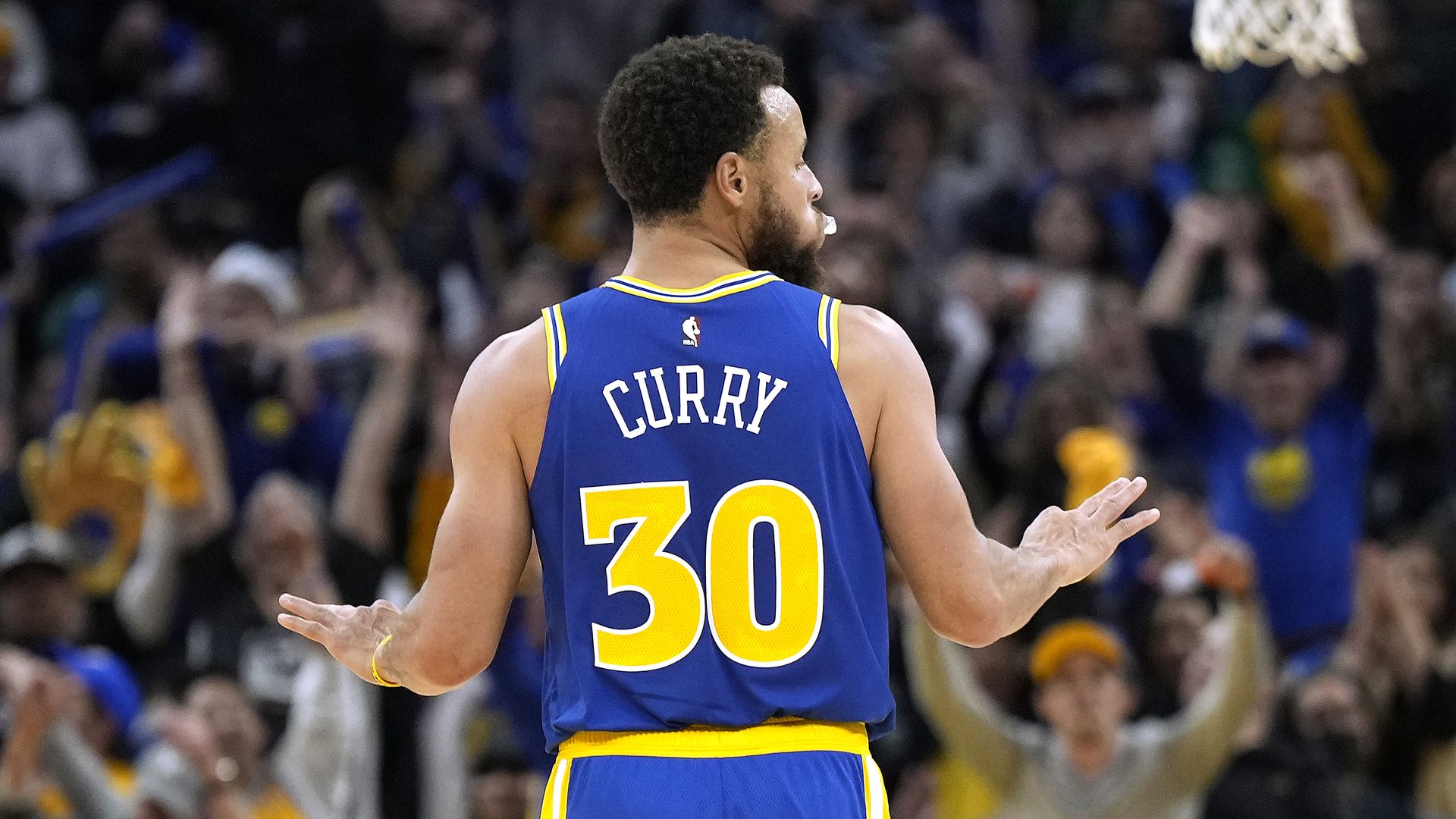 Stephen Curry holding up three fingers