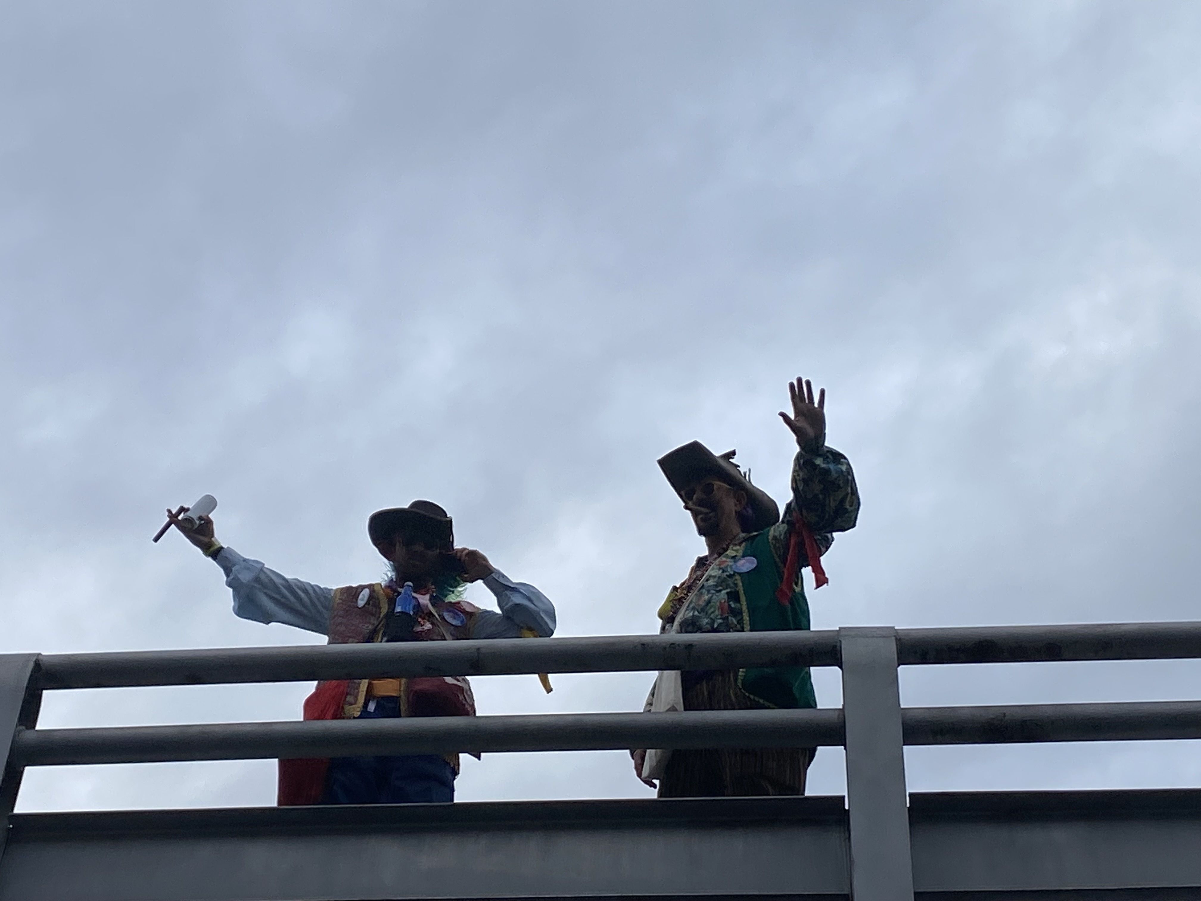 Pirates wave from a bridge.