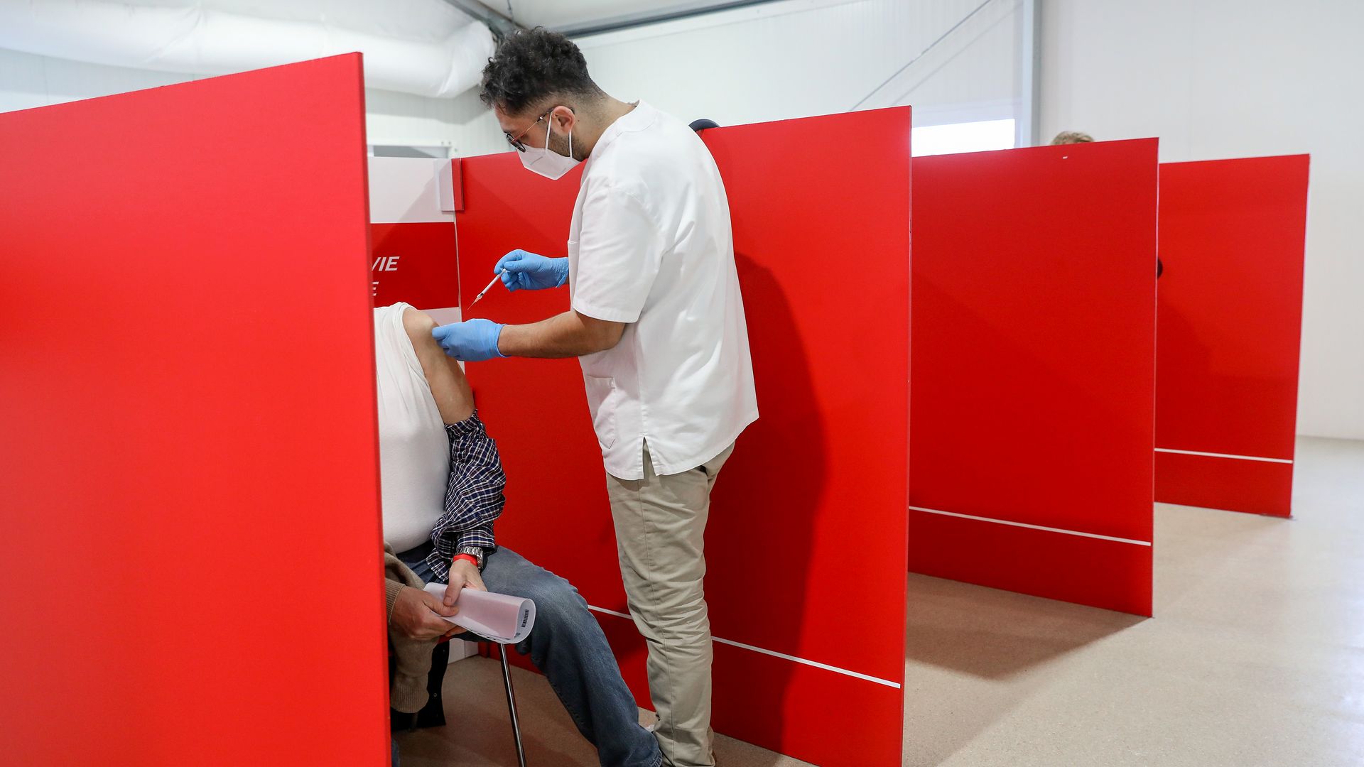 A health worker administers the Covid-19 vaccine at a Covid-19 vaccination center outside Rome's Termini railway station in Rome, Italy, 