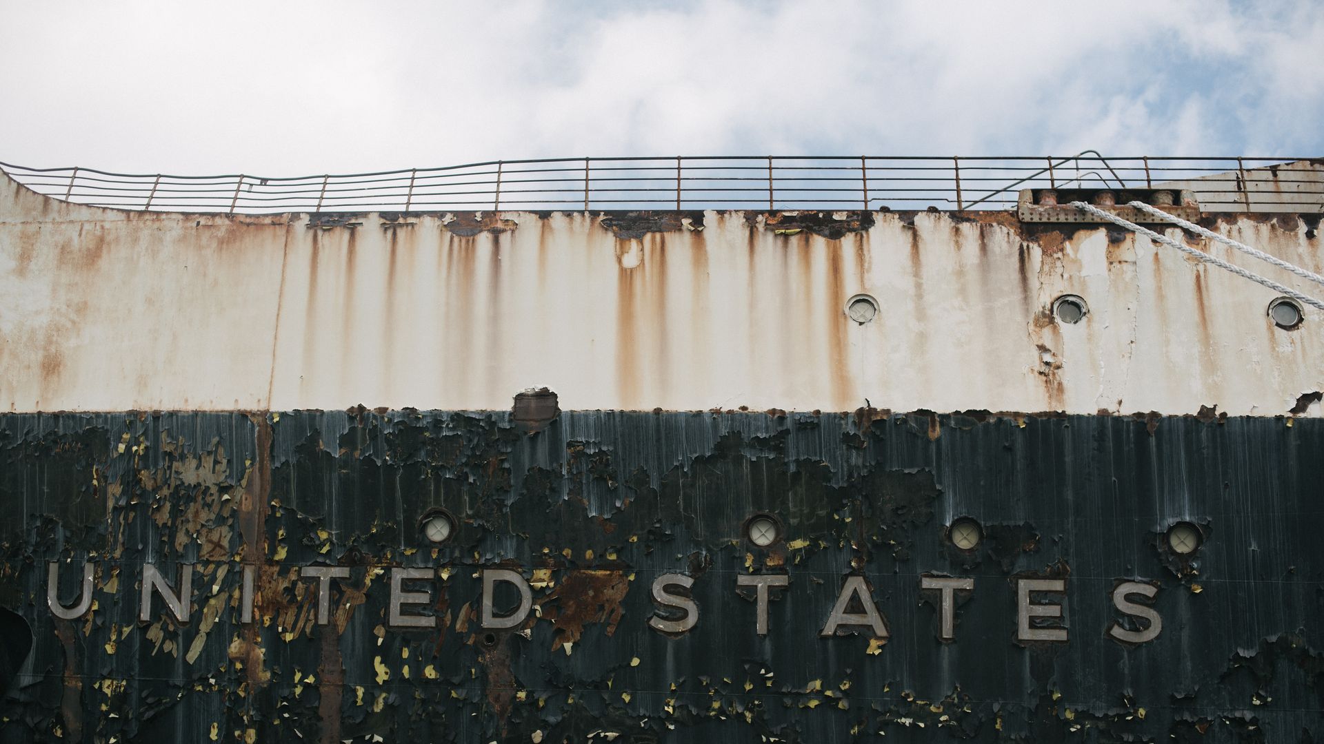 Paint peels around off the SS United States, which is docked in South Philly. The ship faces a looming deadline to relocate.