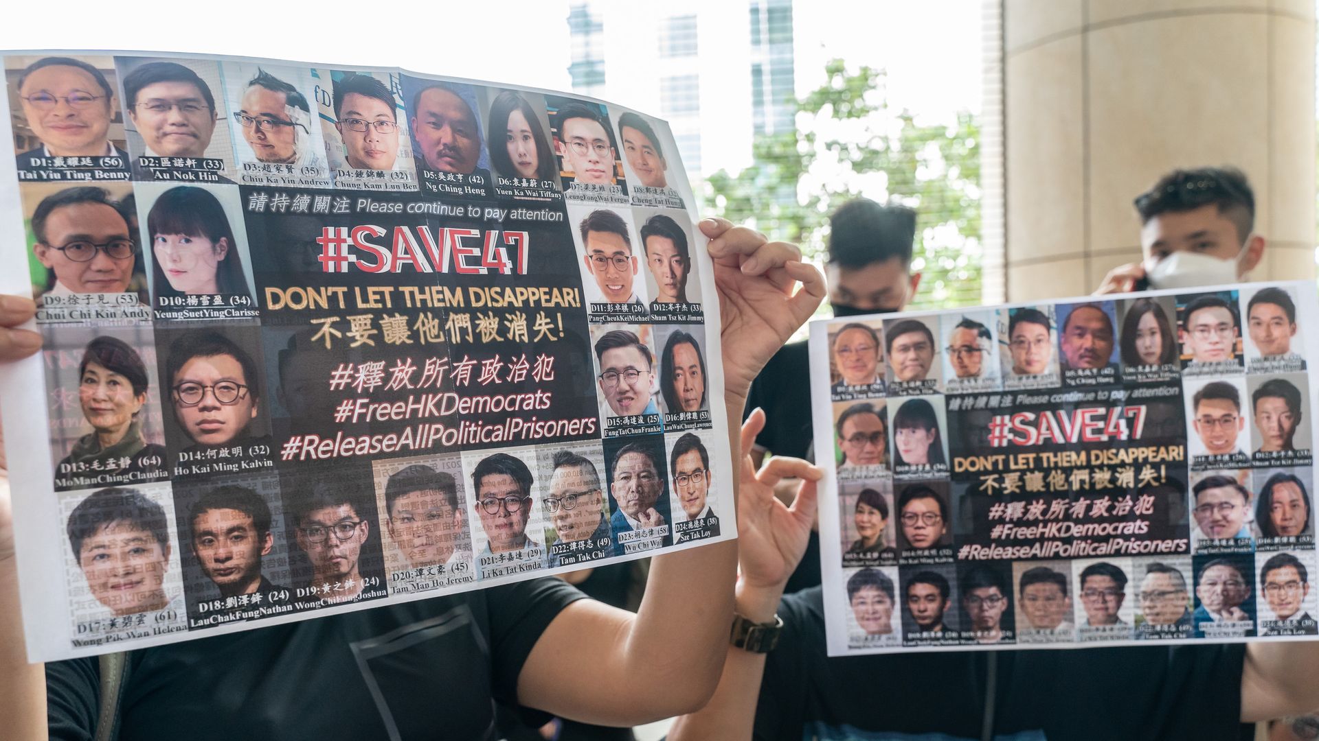 Supporters hold signs with images of Hong Kong pro-democracy activists outside the courts