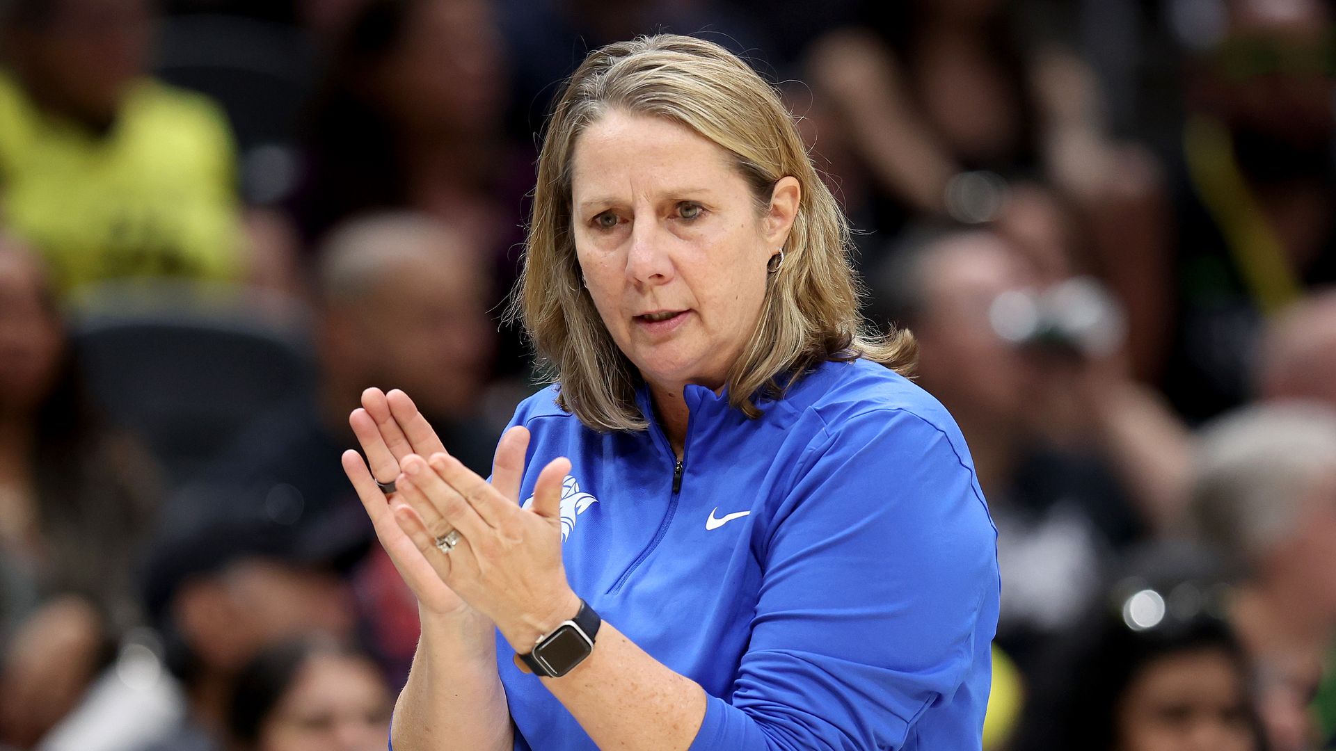 A photo of Cheryl Reeve clasping her hands on the sideline 