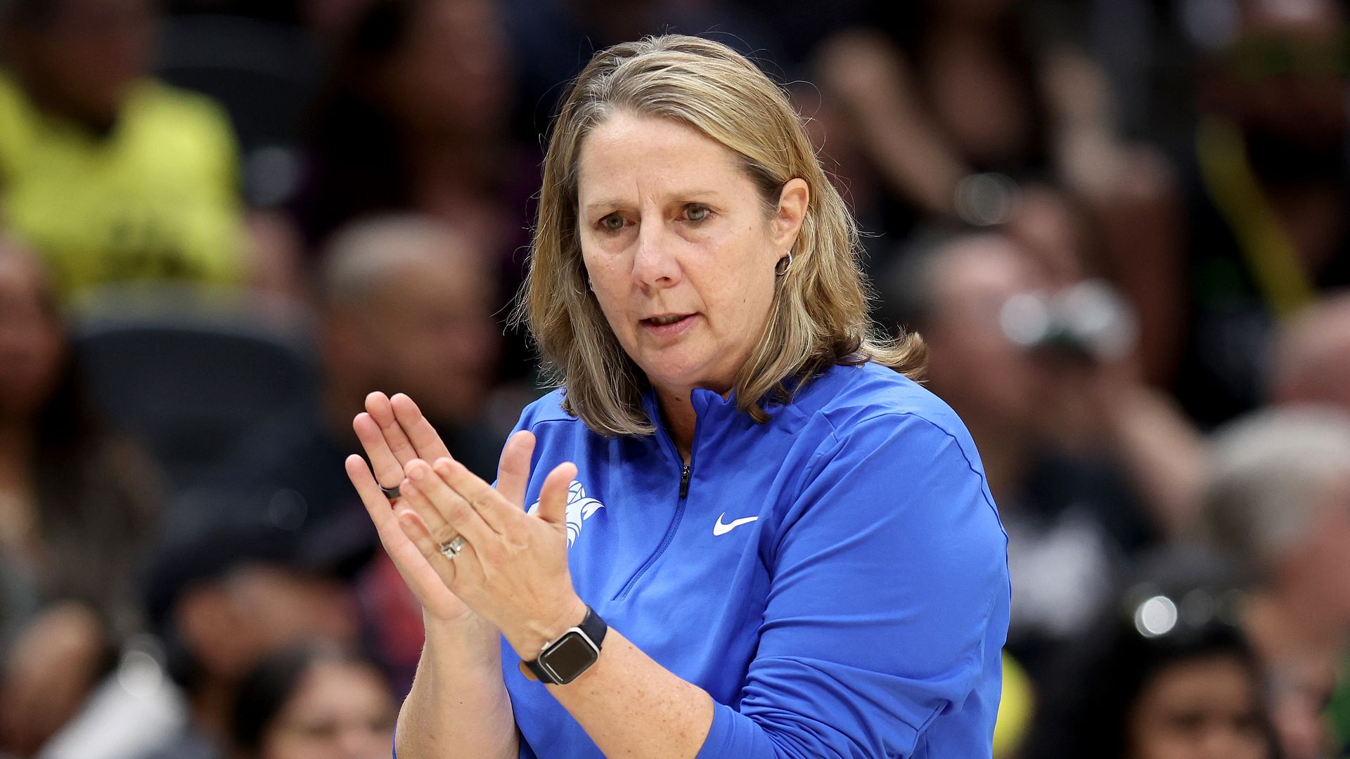 A photo of Cheryl Reeve clasping her hands on the sideline 